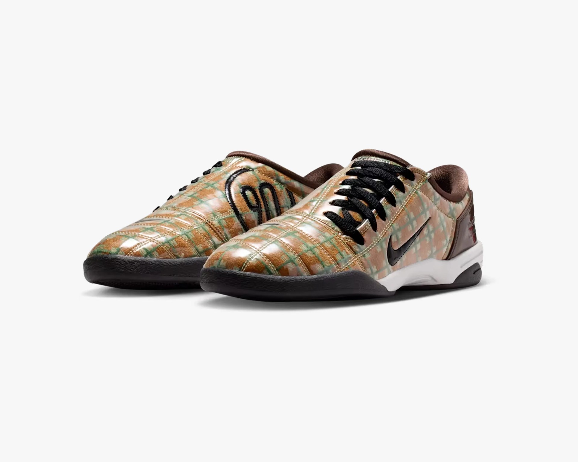Pair of low-top sneakers with a shiny, multicolored plaid pattern, black laces, and white midsoles.