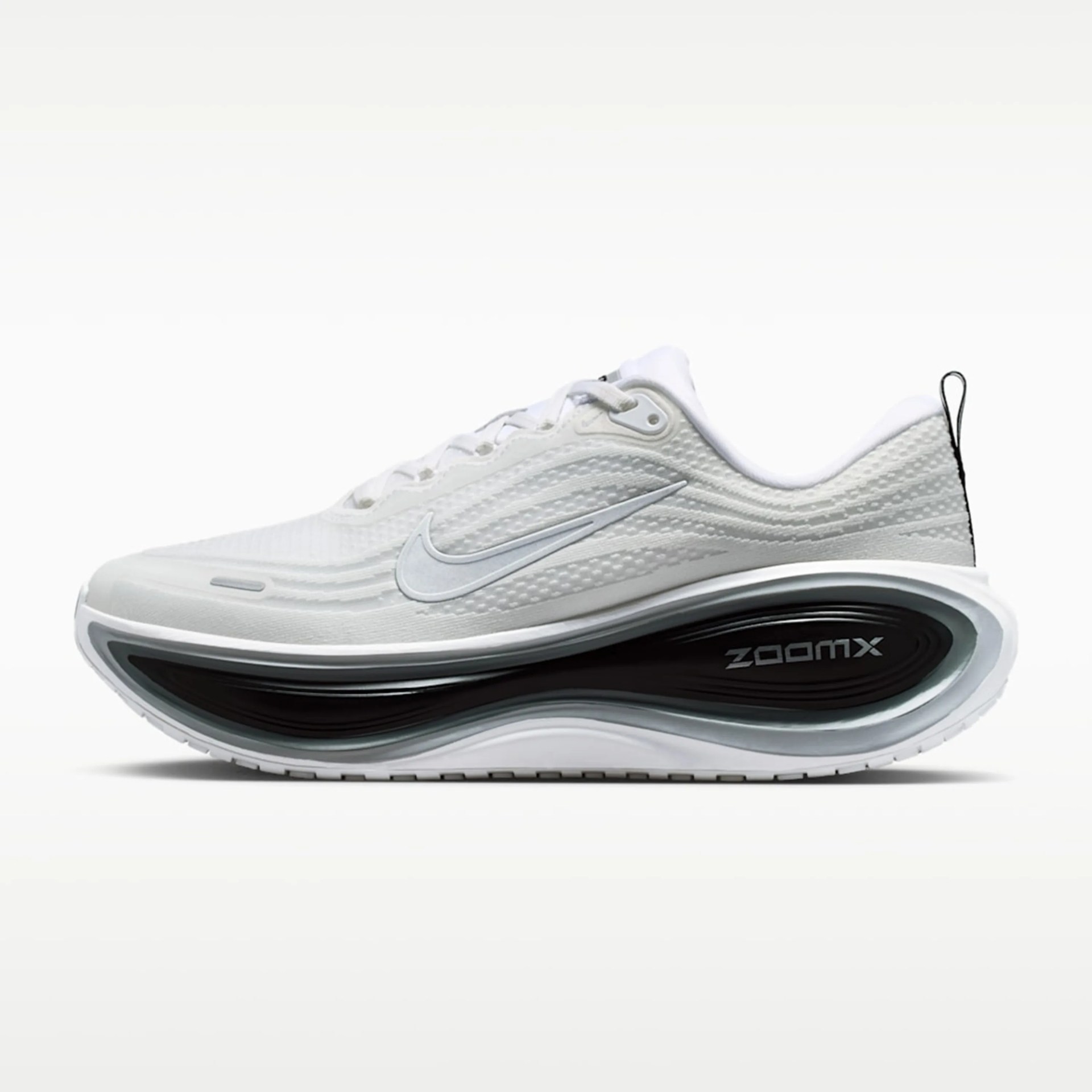 White Nike ZoomX running shoe with textured upper and black cushioned sole.