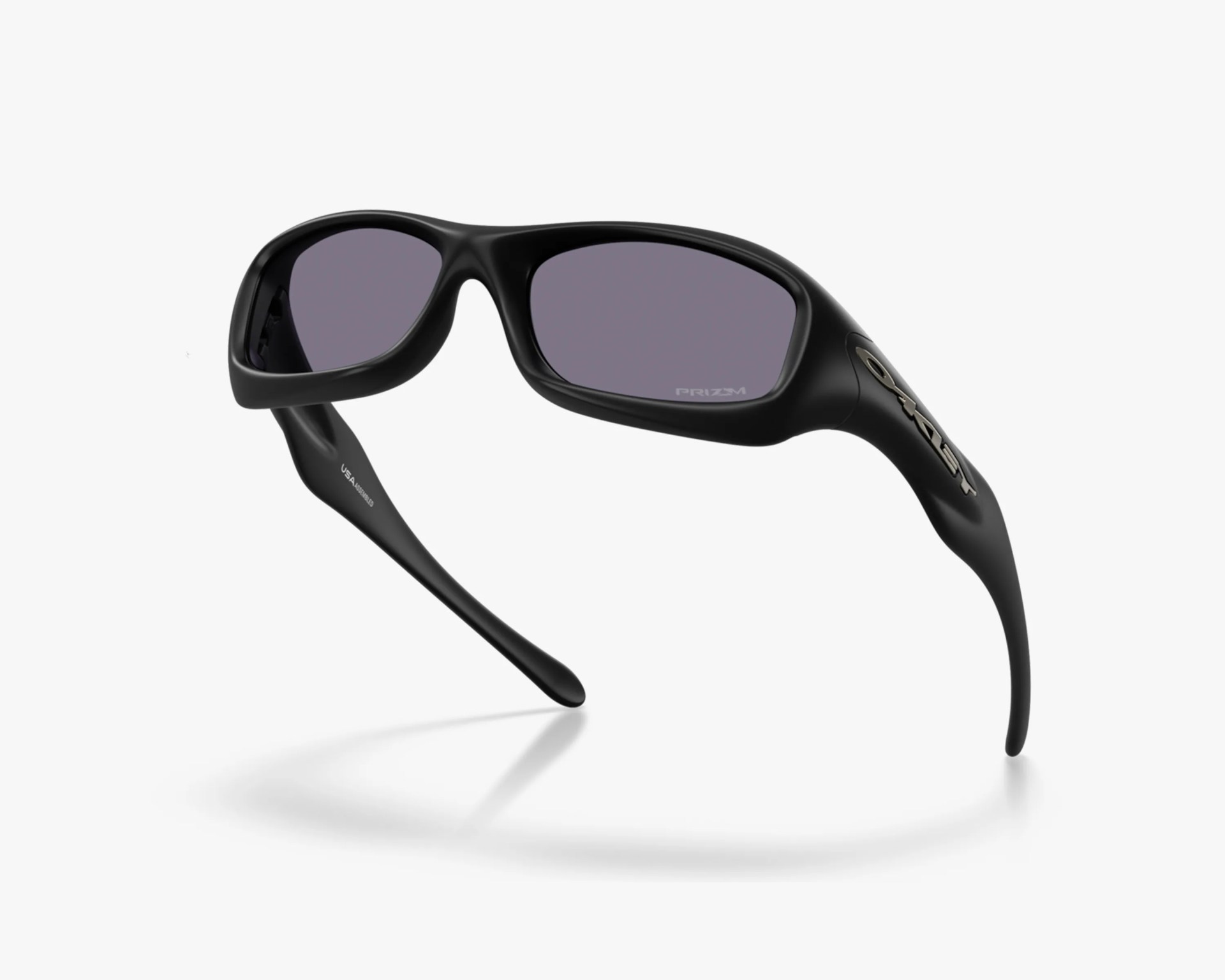 Black wraparound sunglasses with thick frames and dark lenses, featuring Oakley logo on the temple.