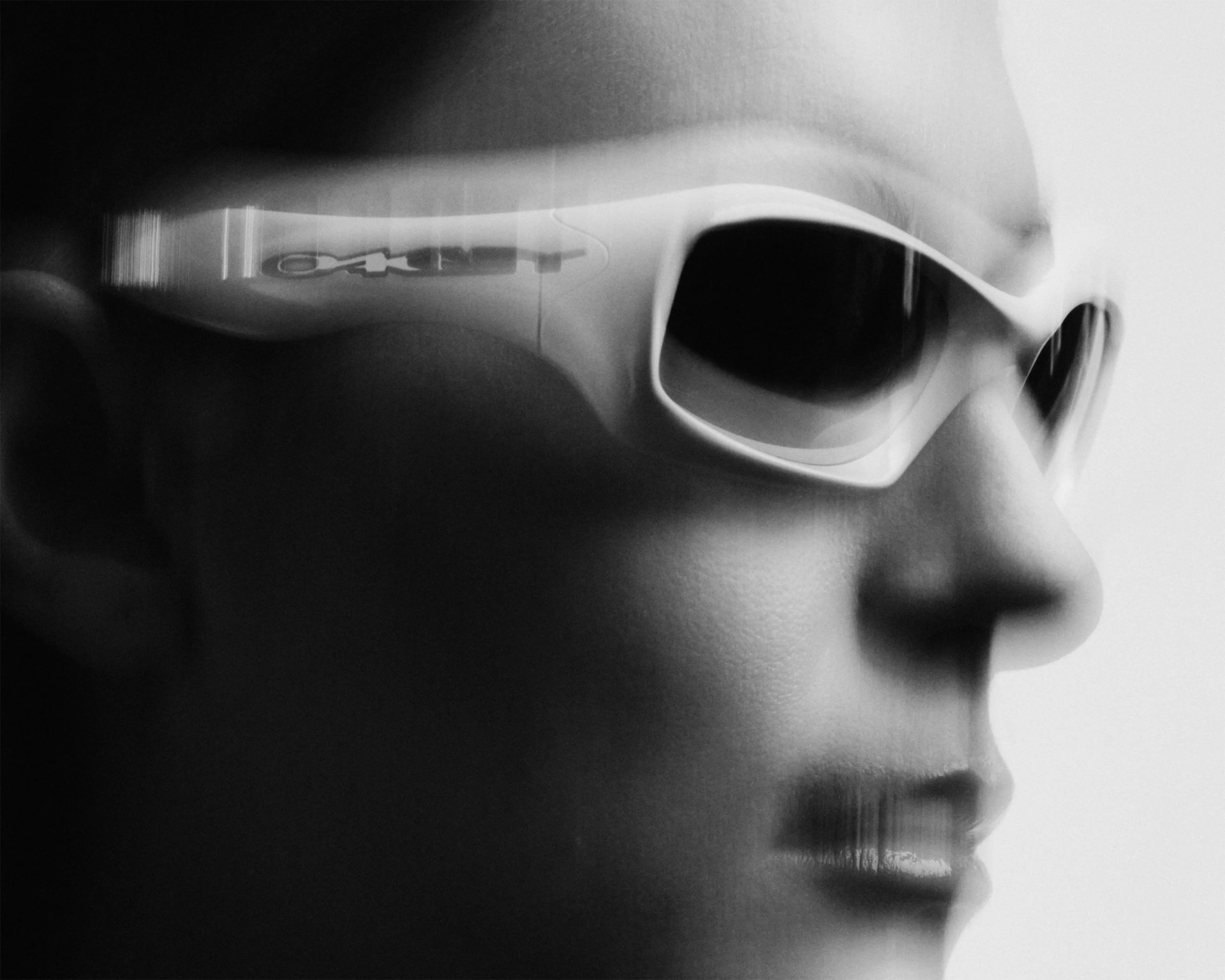 Close-up black and white side profile of a person wearing white sunglasses with dark lenses.