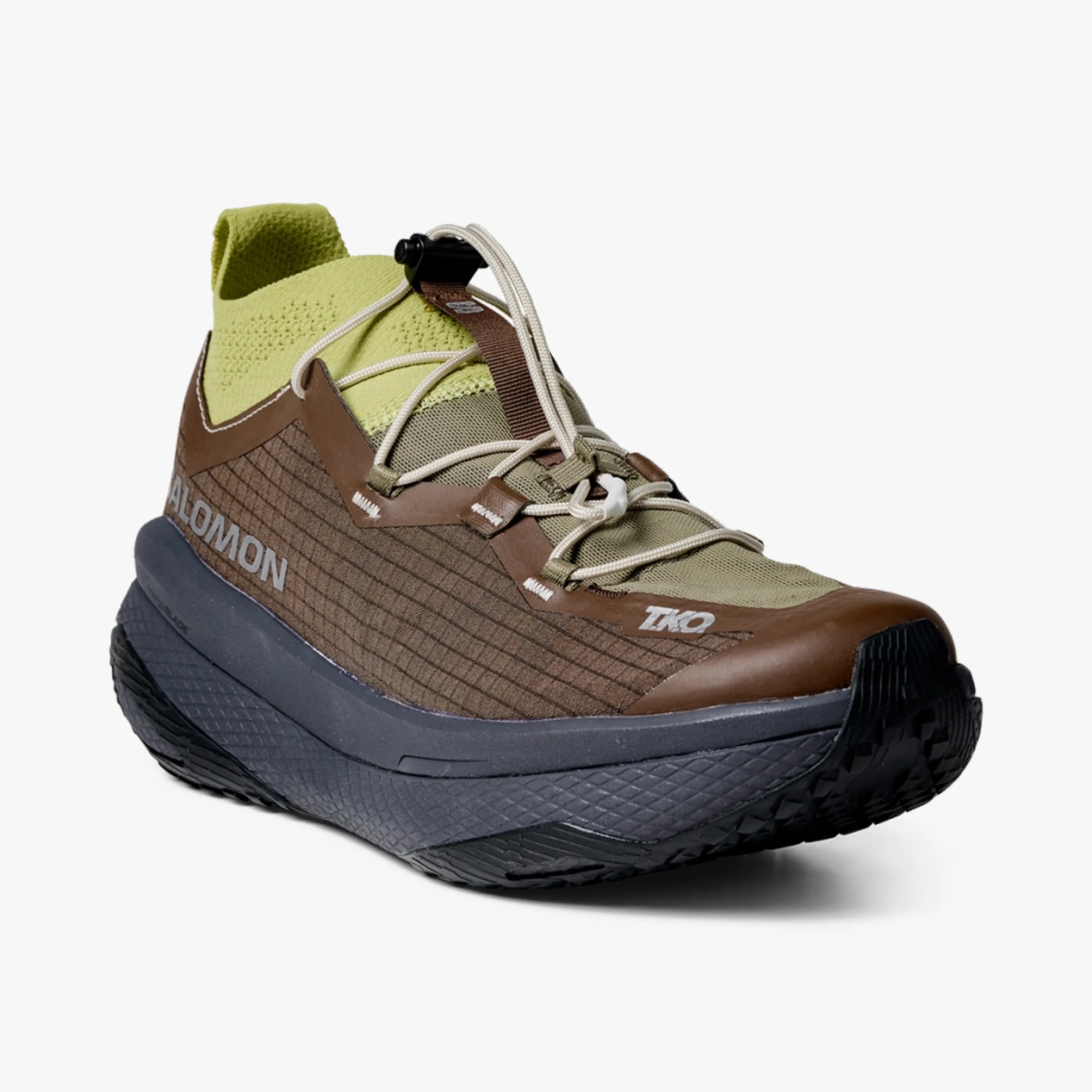 Brown and olive green Salomon TKO sneaker with white laces and black textured sole.