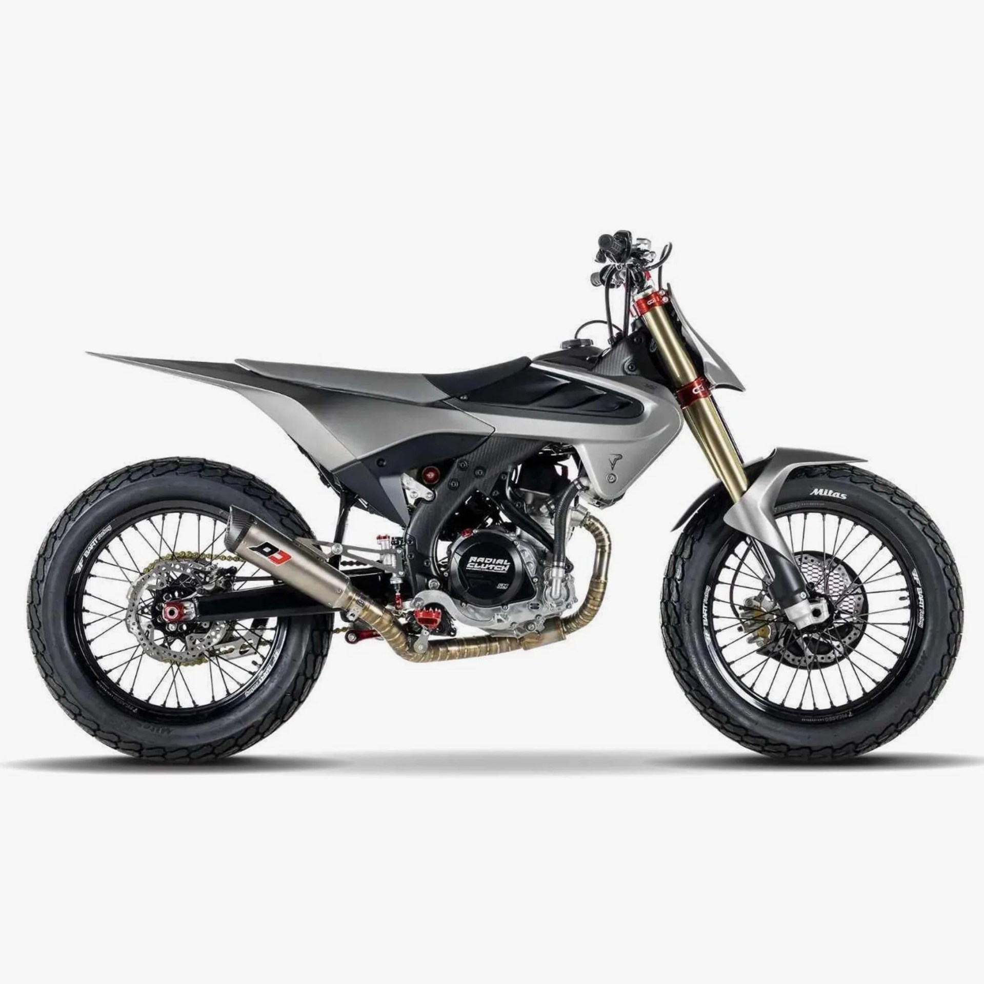 Silver and black off-road motorcycle with gold front forks and knobby tires on a white background.