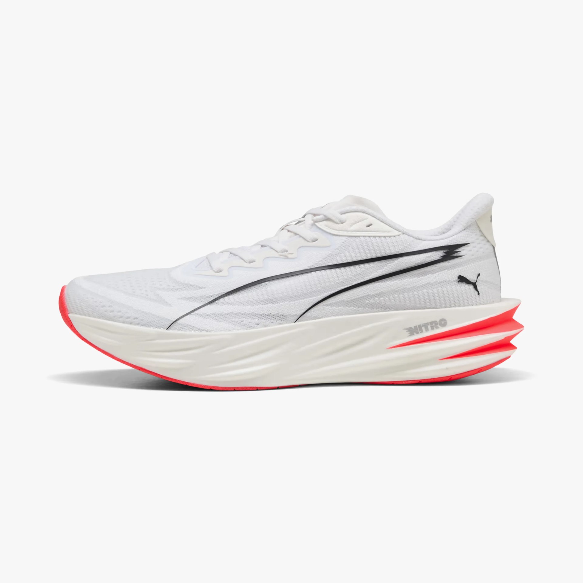 White Puma running shoe with black logo and red sole accents.