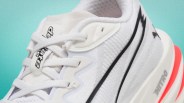Close-up of a white Puma Nitro running shoe with black logo and red accent on the sole.