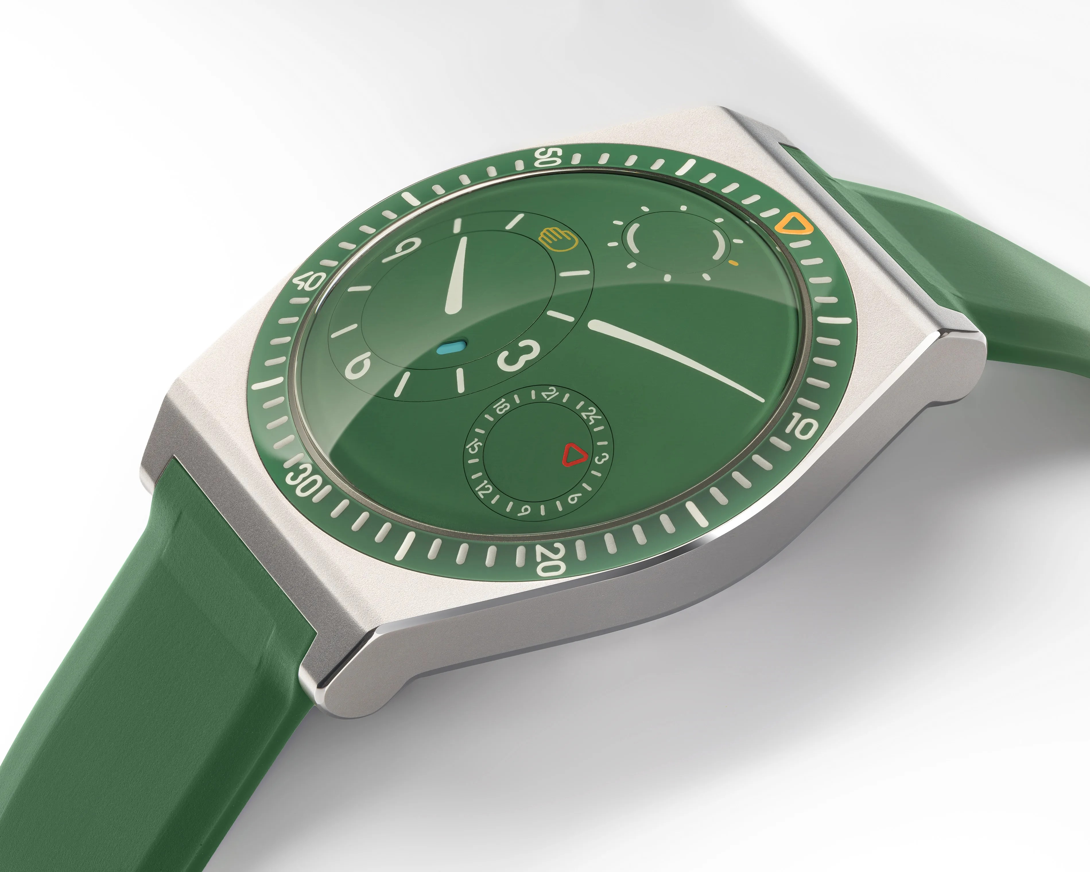 Green watch face with white and yellow markings, silver case, and green strap on a white background.
