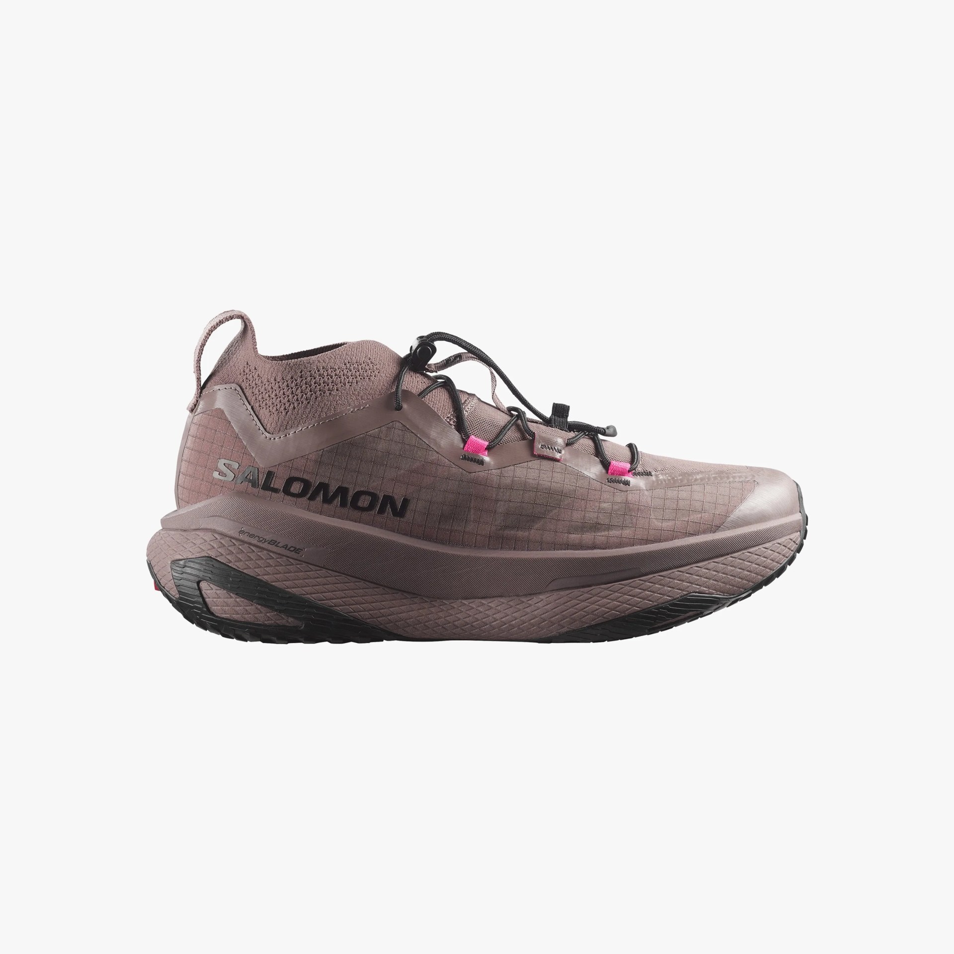 Mauve Salomon trail running shoe with black sole and pink lace loops.