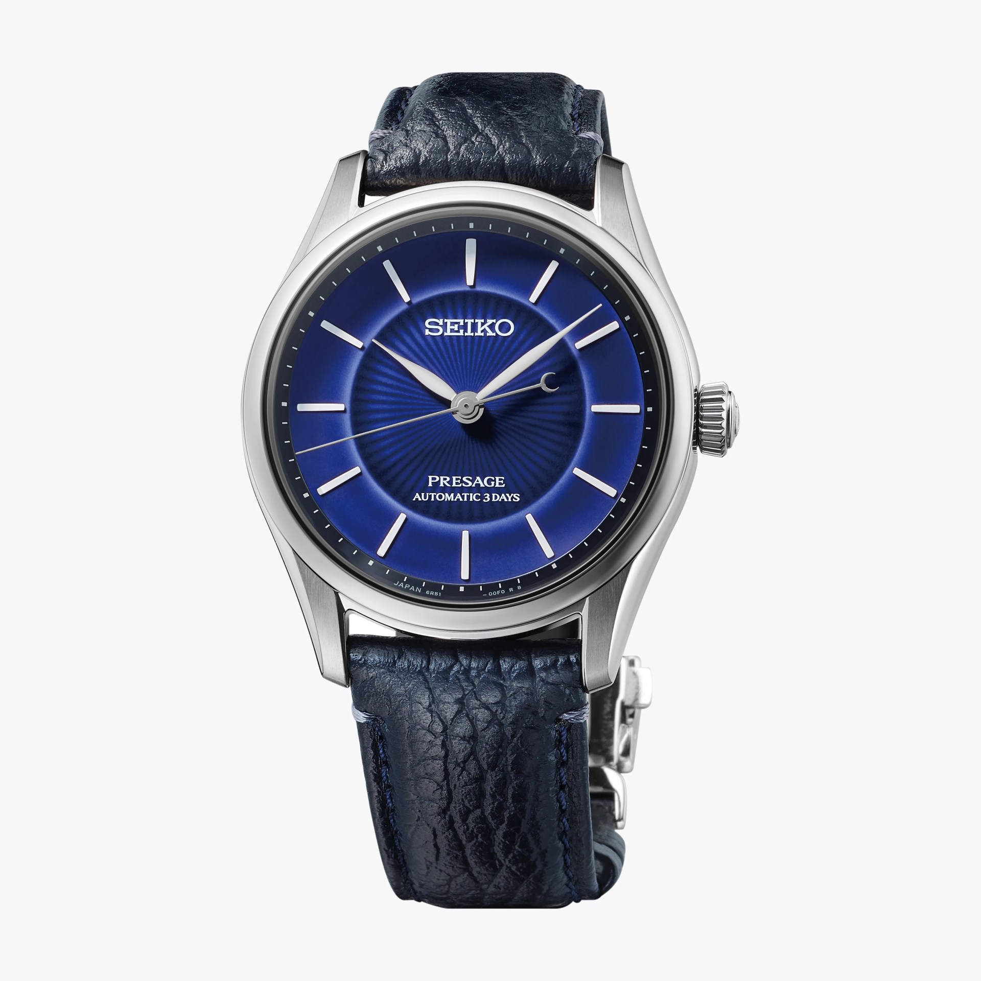 Seiko Presage watch with a deep blue sunburst dial, silver markers, and a textured dark blue leather strap.