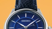 Close-up of a Seiko watch with a blue sunburst dial, silver hour markers, and a black leather strap.