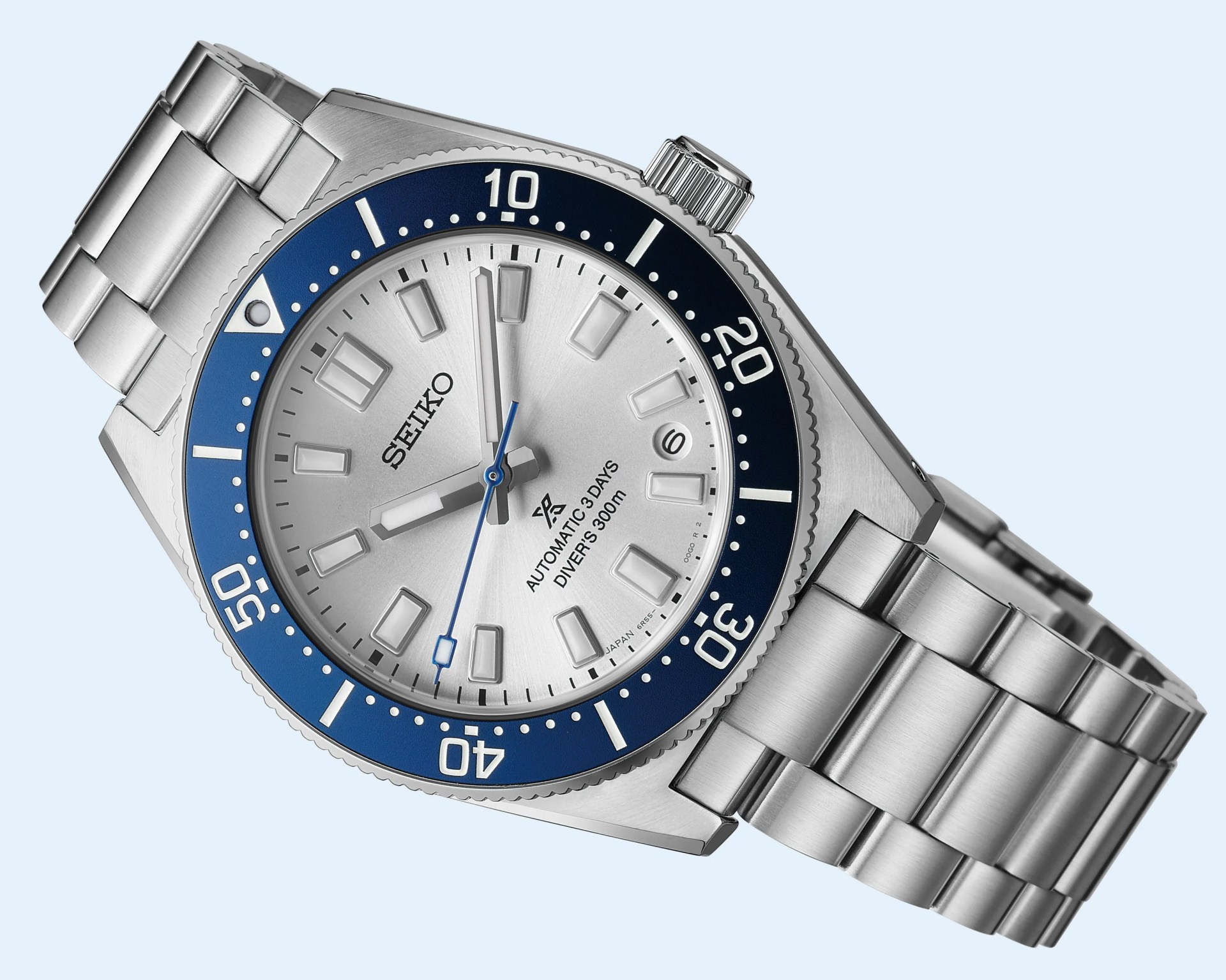 Silver Seiko automatic diver's watch with blue bezel and stainless steel bracelet.