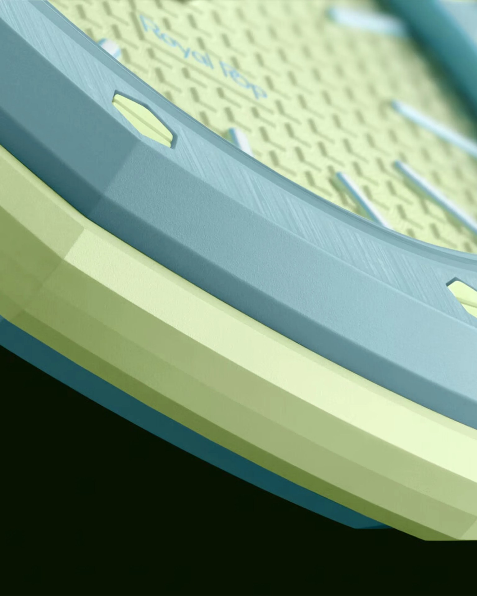 Close-up of a blue and yellow tennis racket frame with "Royal Flop" text on the yellow string bed.