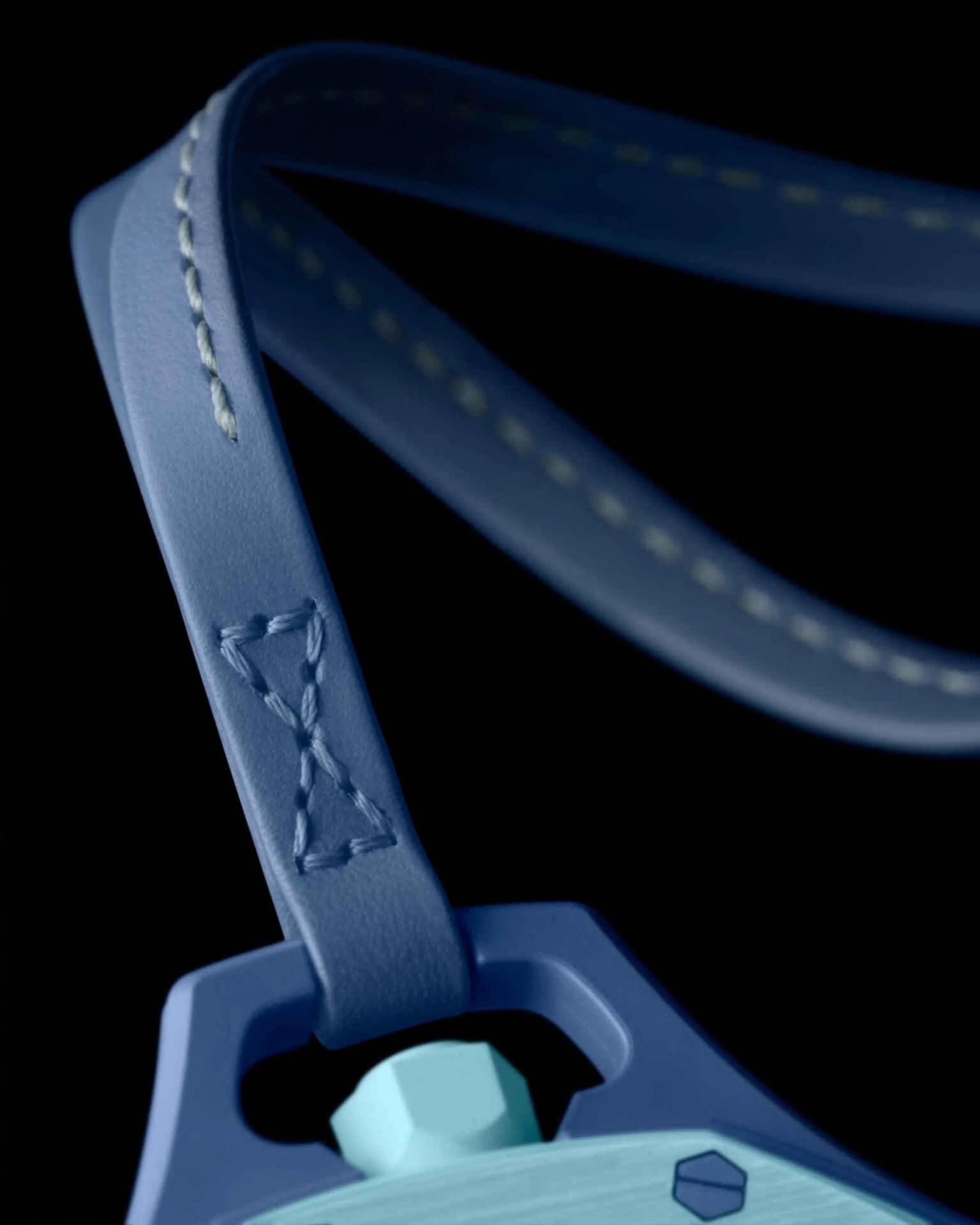 Close-up of a blue leather strap with detailed stitching attached to a blue plastic piece with a light blue hexagonal knob.
