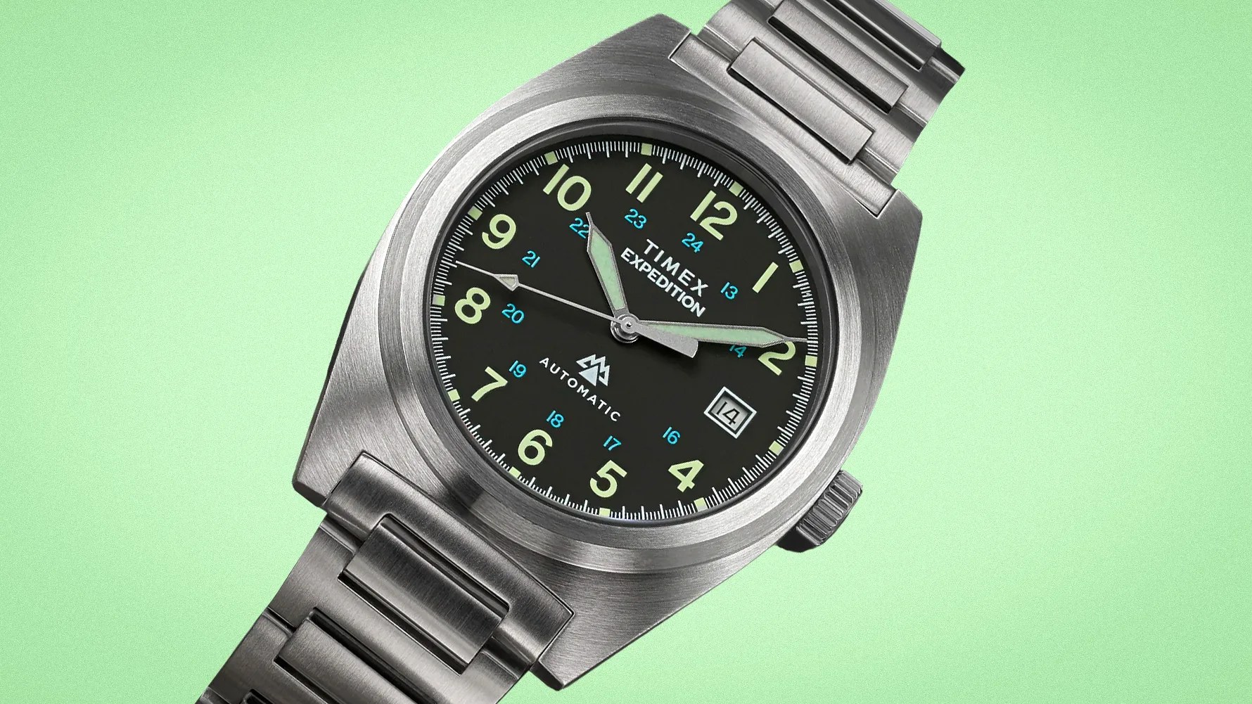 Stainless steel Timex Expedition automatic watch with black dial, luminous numerals, and date window on green background.