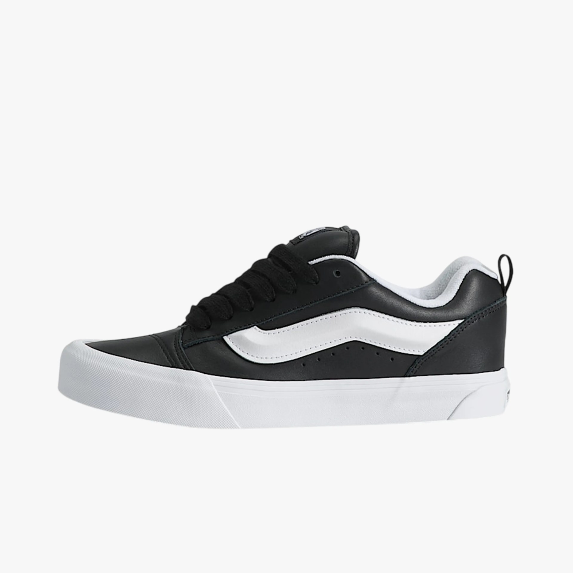 Black and white low-top sneaker with thick white sole and black laces.