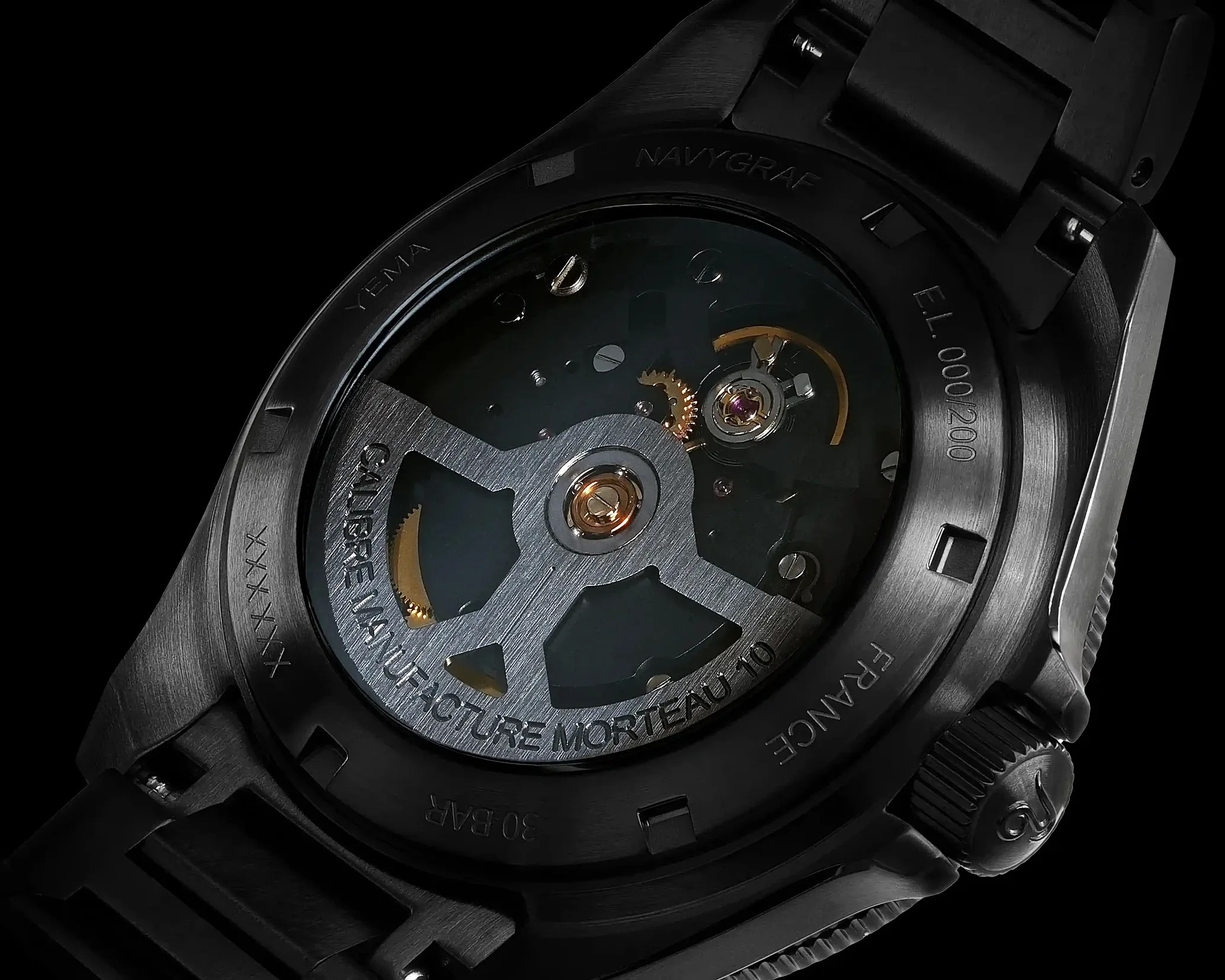 Close-up of a black Yema Navygraf watch back showing the mechanical movement and engraved text on the case.