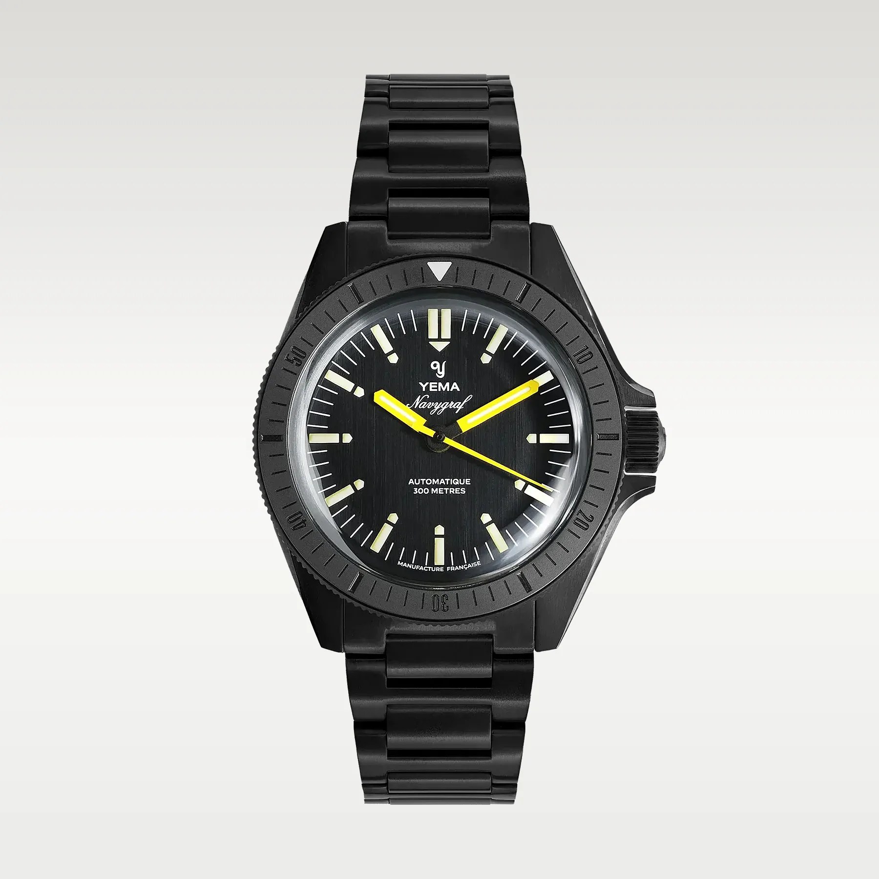 Black Yema Navygraf wristwatch with yellow hands and luminous hour markers on a black metal bracelet.