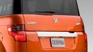 Rear view of an orange Honda Element 4WD with visible taillights and license plate CR70986.