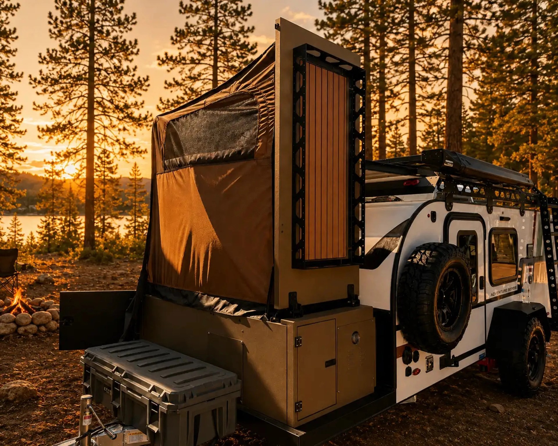 White off-road camper trailer with rooftop tent and spare tire mounted on the side, set in a forest at sunset.