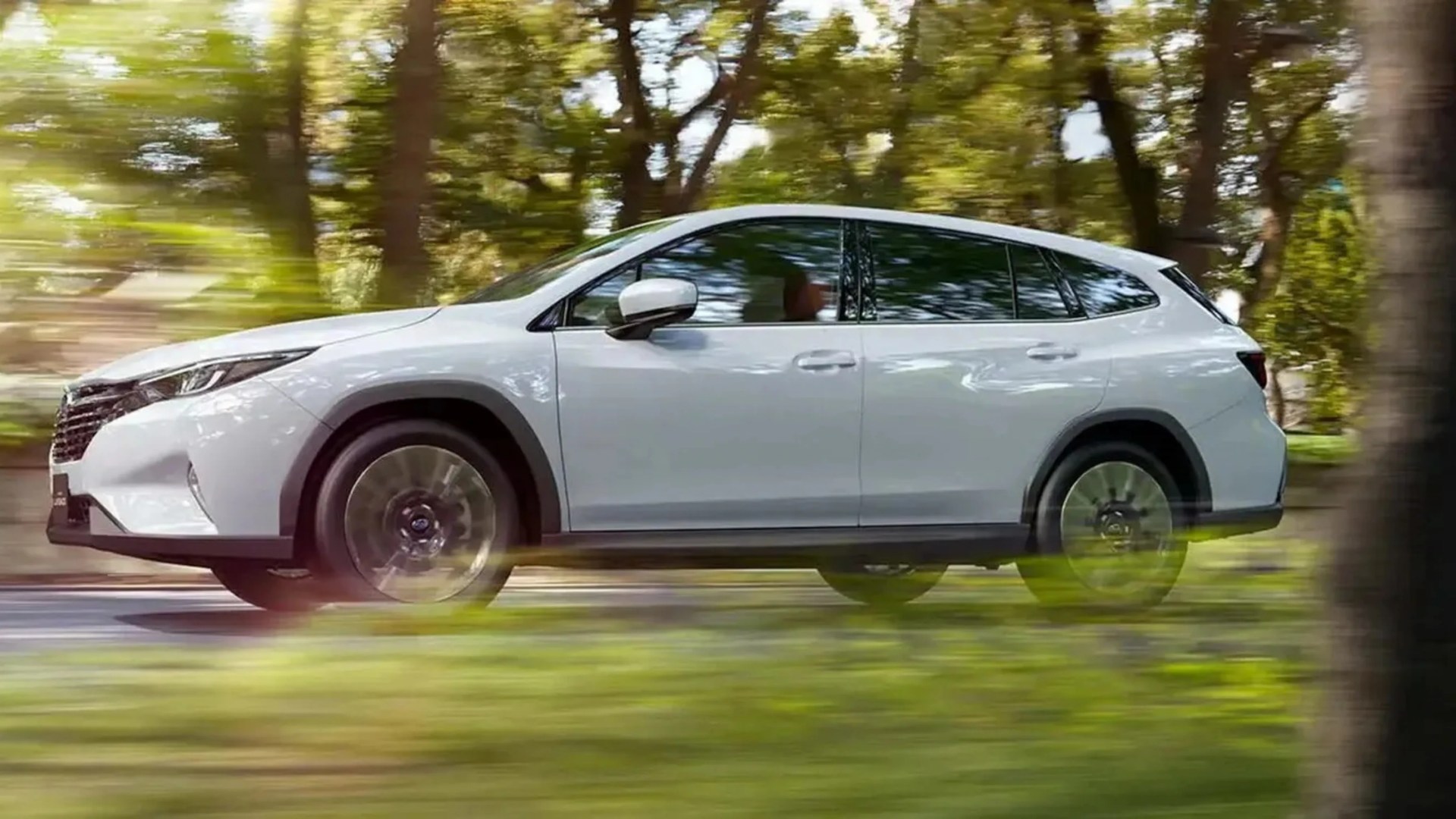 White Subaru SUV driving on a road with blurred green trees in the background.