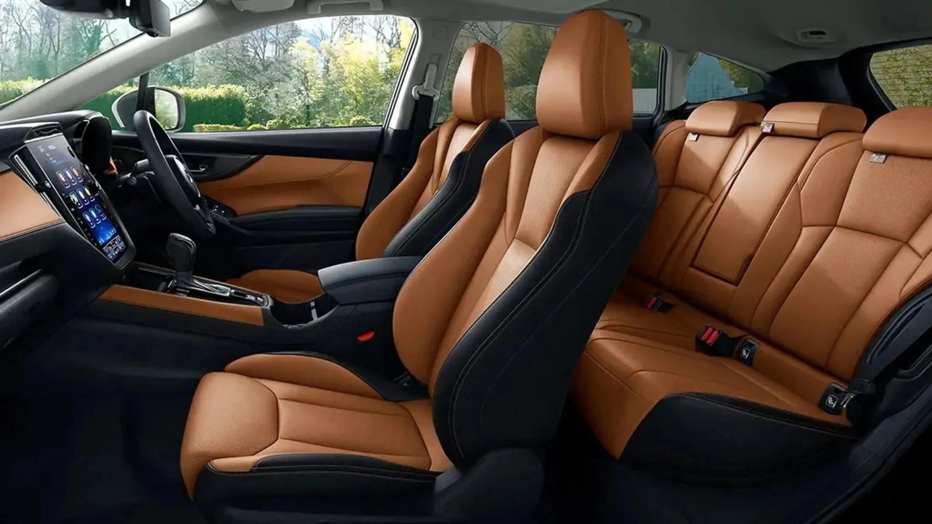 Car interior with tan leather seats featuring black side panels and a large vertical touchscreen on the dashboard.