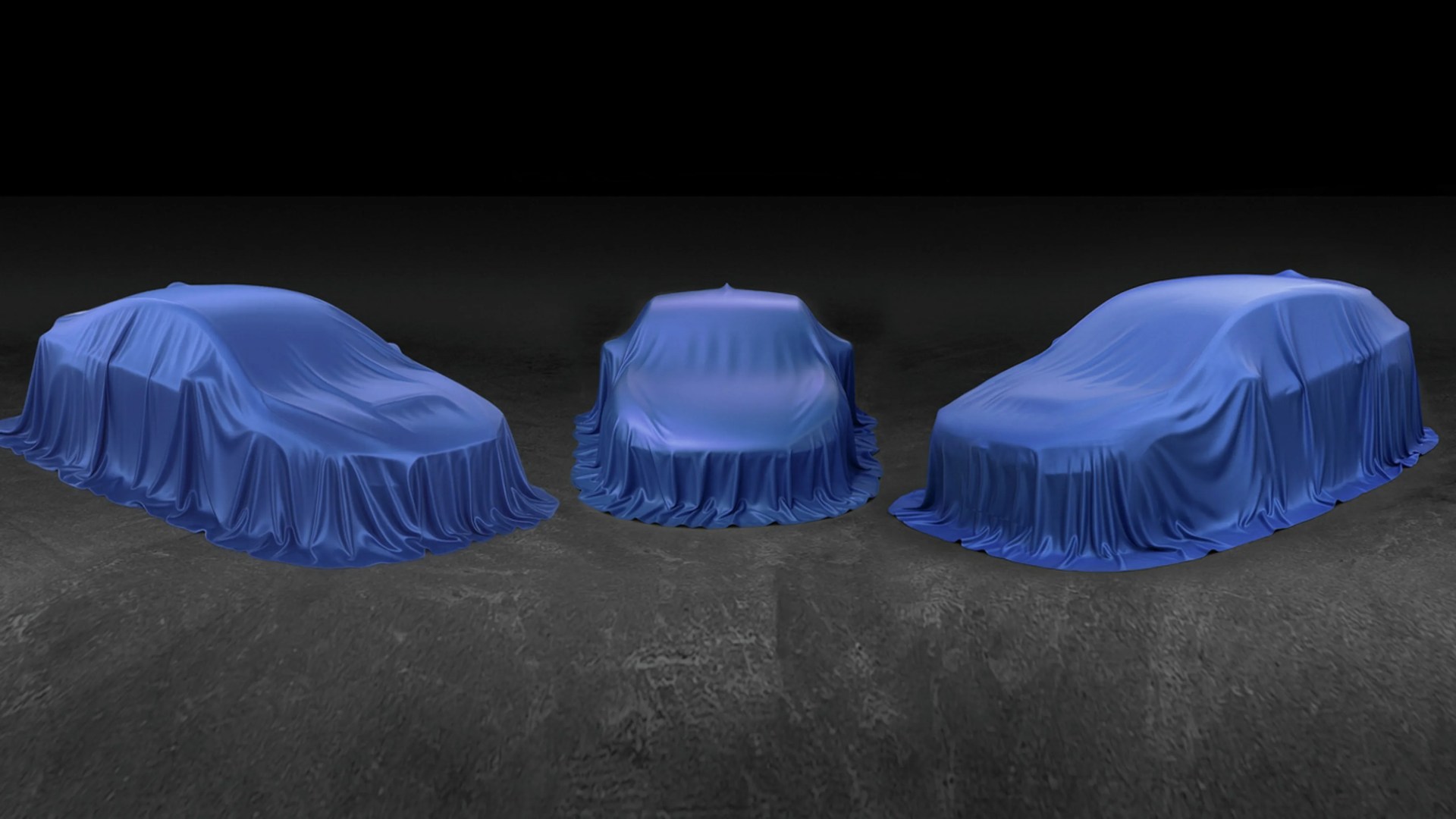 Three cars covered with blue satin cloths on a dark concrete floor.