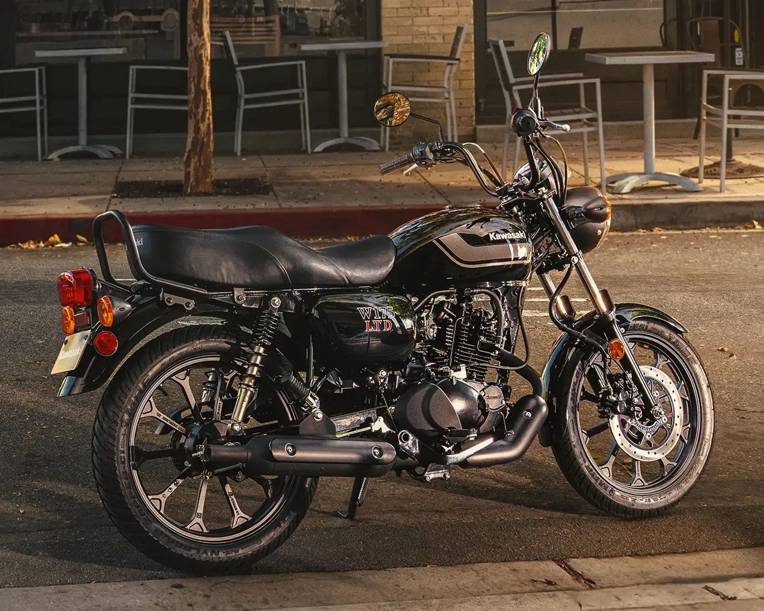 Black Kawasaki W175 LTD motorcycle parked on a street with chrome accents and round mirrors.