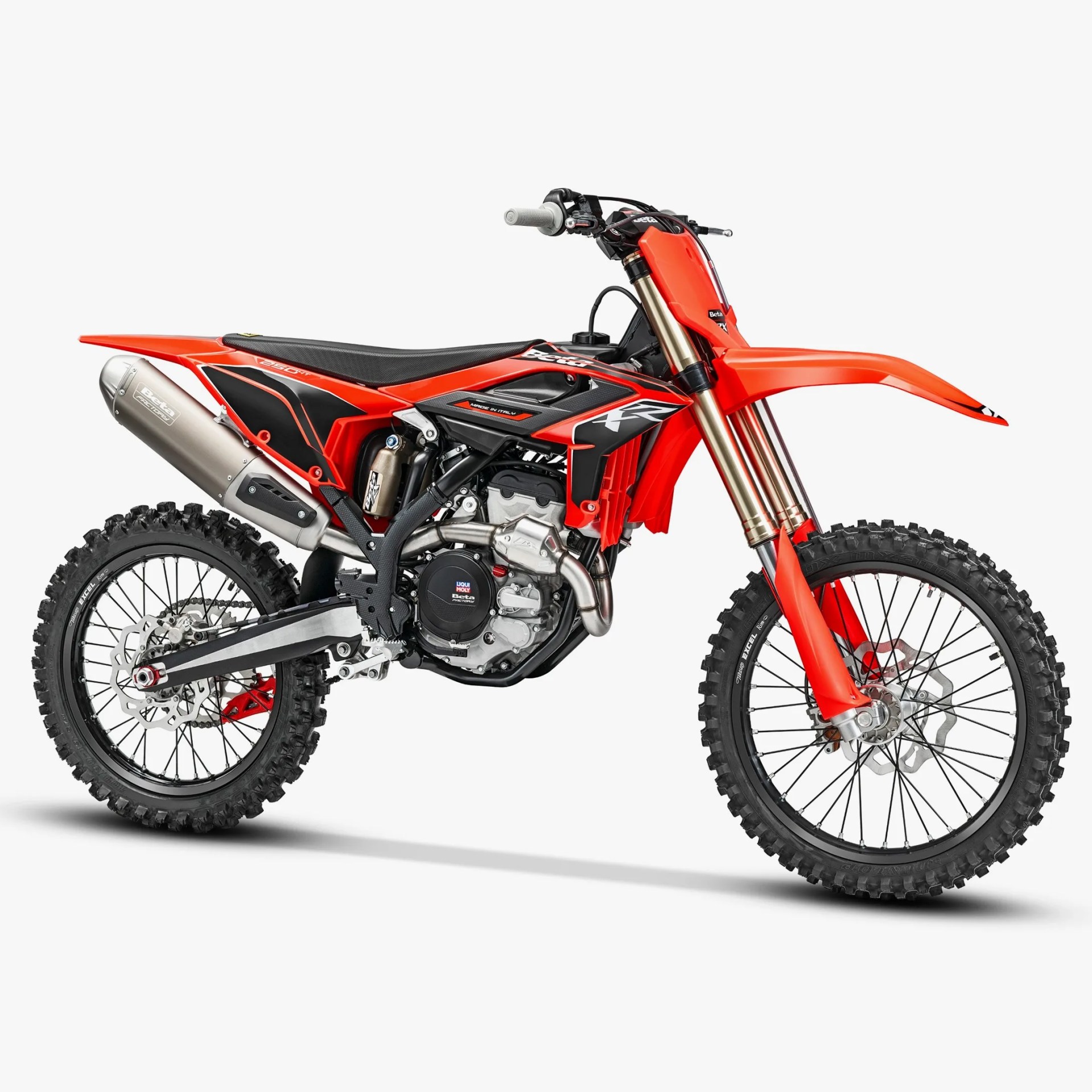 Red and black Beta 250 RX dirt bike with knobby tires and silver exhaust on a white background.