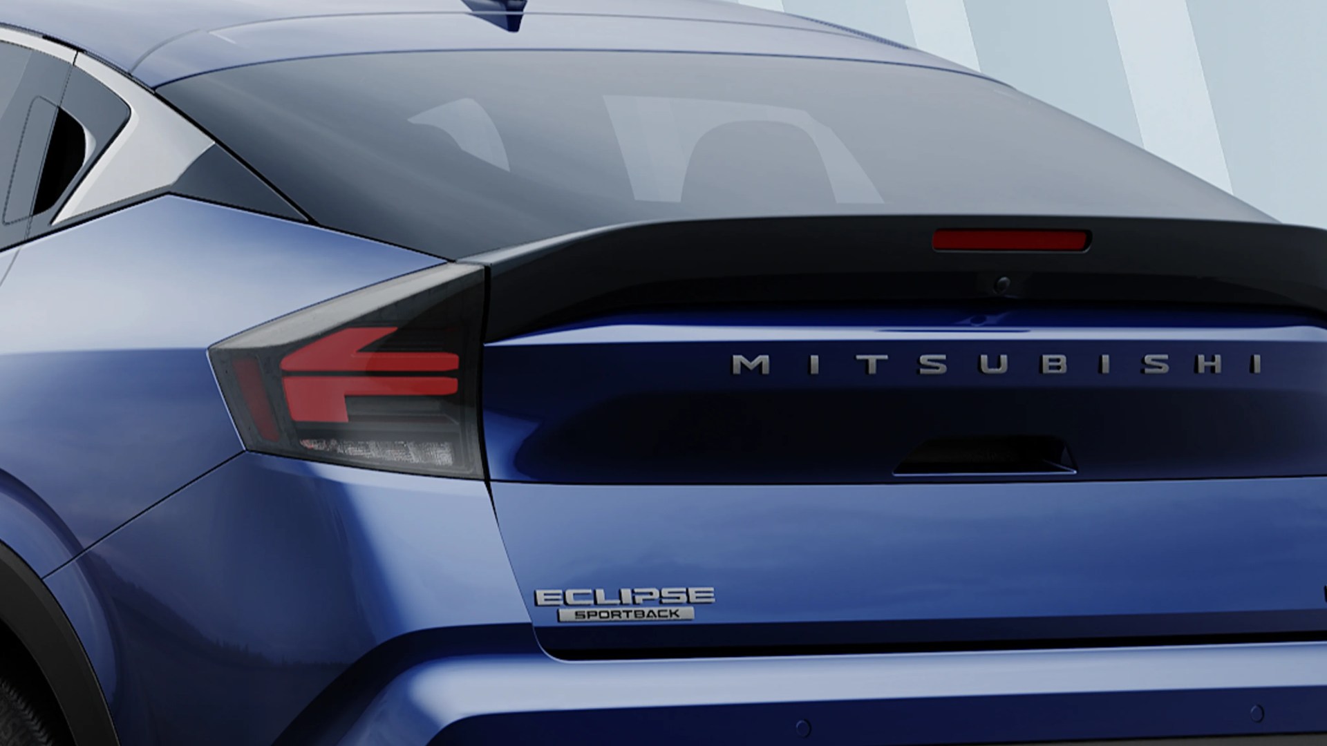Rear view of blue Mitsubishi Eclipse Sportback showing taillight and rear window.