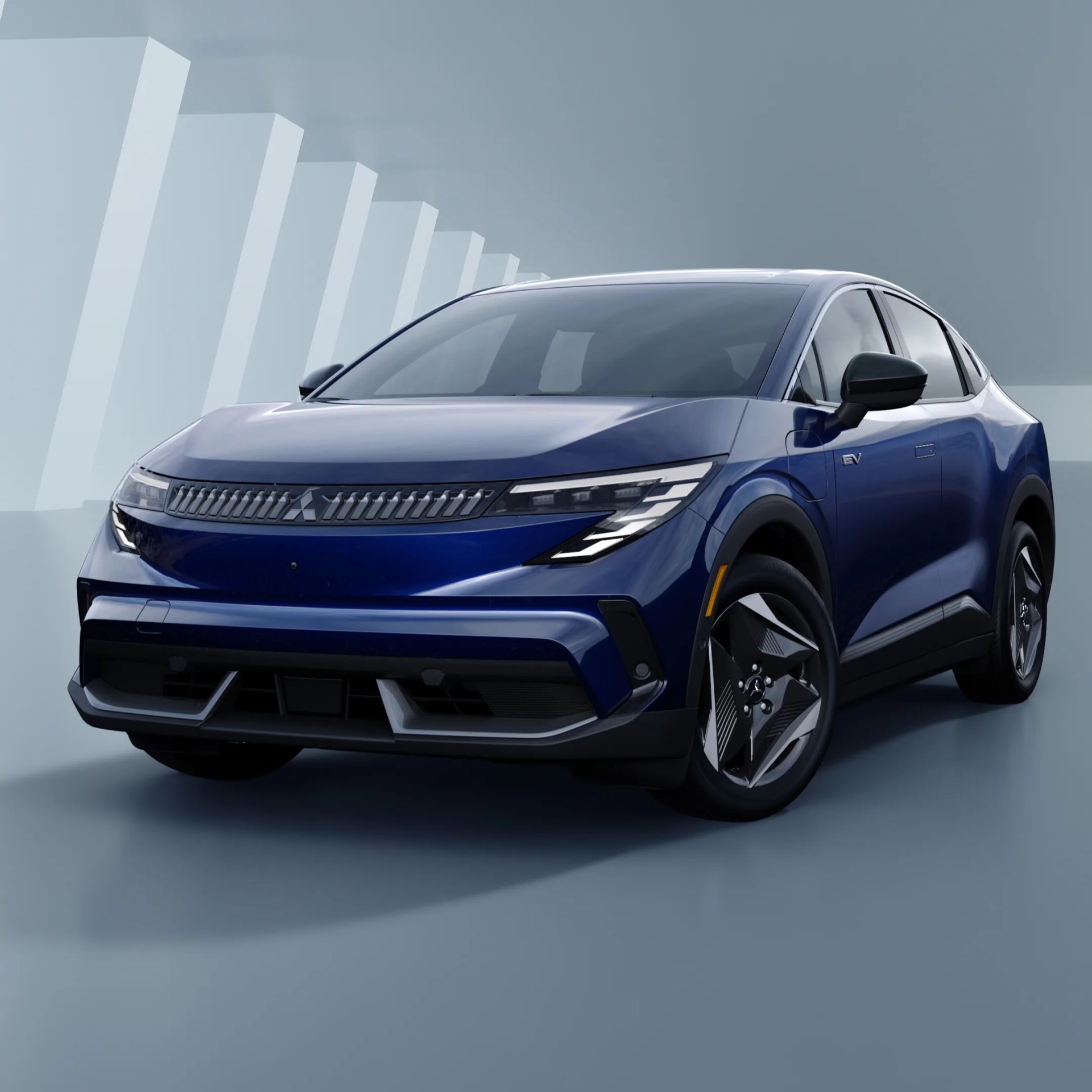 Blue electric SUV with sleek headlights and black side mirrors against a gray geometric background.