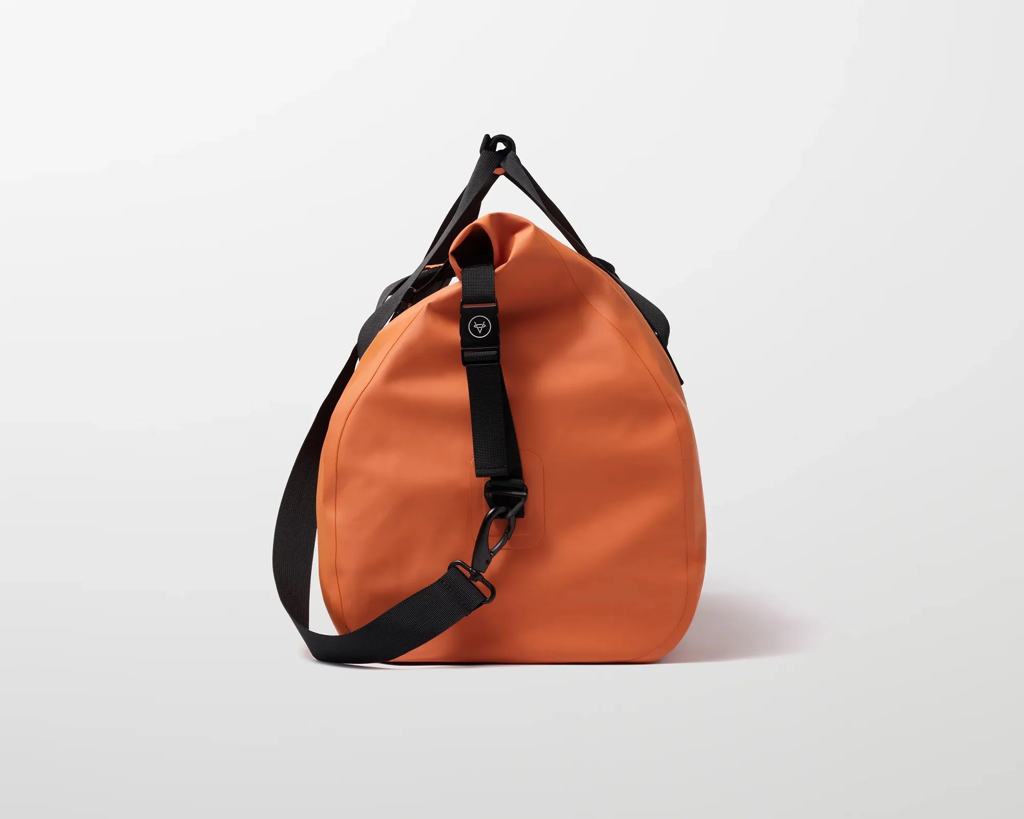 Orange waterproof duffel bag with black adjustable strap and buckle on a white background.