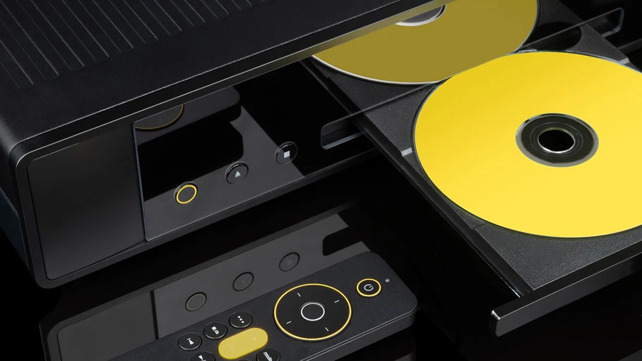 Black DVD player with an open tray holding two yellow discs and a matching black remote with yellow accents.