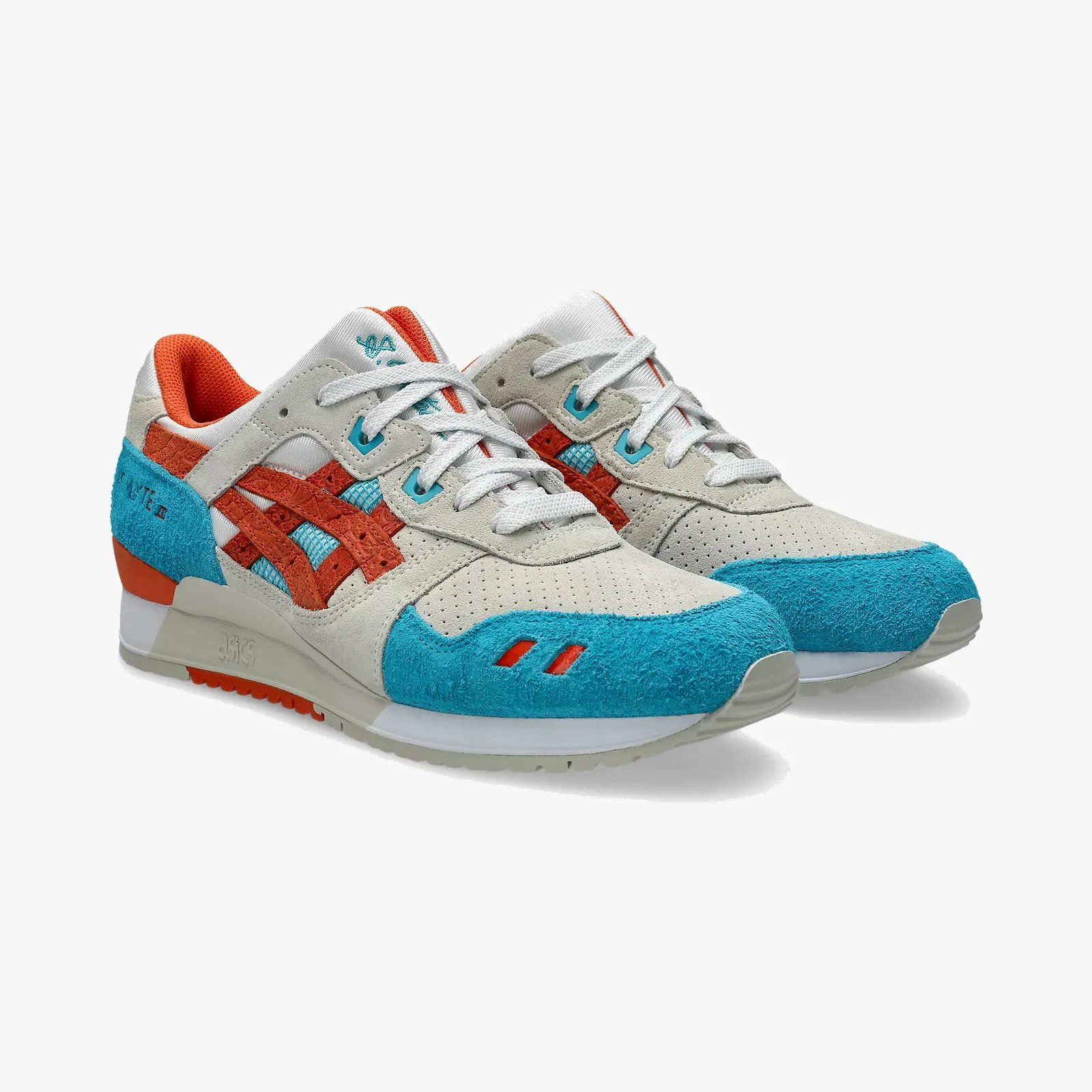 Pair of beige, blue, and orange ASICS sneakers with suede and mesh materials.