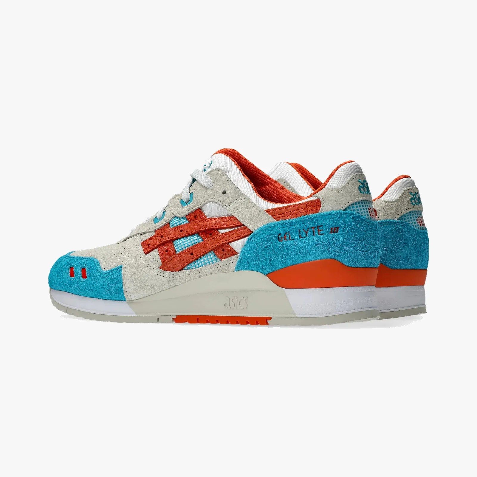 Pair of Asics Gel Lyte III sneakers in beige, orange, and blue with suede and mesh panels.