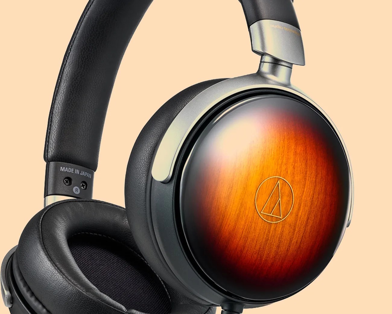 Over-ear headphones with black leather padding and wooden ear cups featuring the Audio-Technica logo.