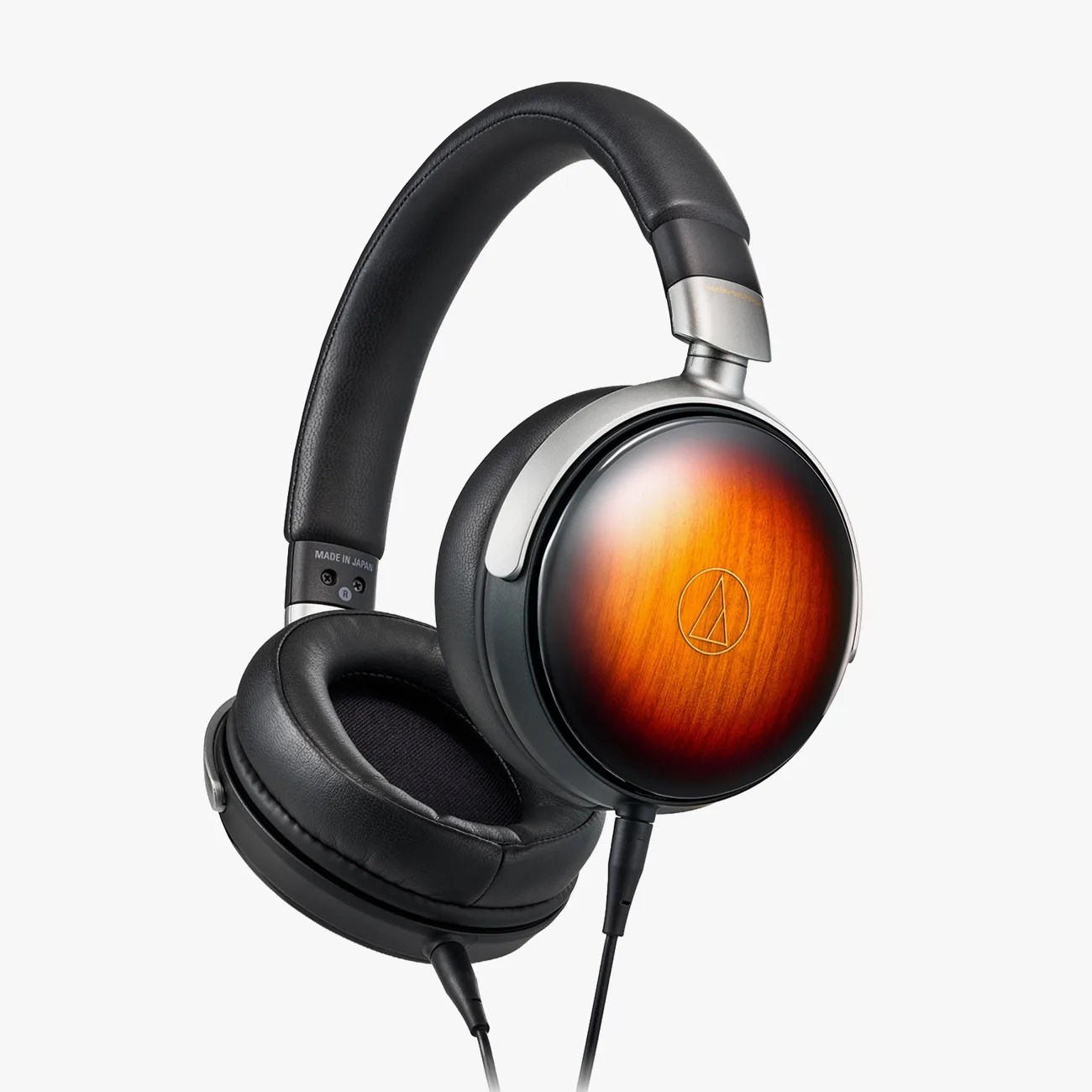 Over-ear headphones with black leather padding and wooden ear cups with a sunburst finish.