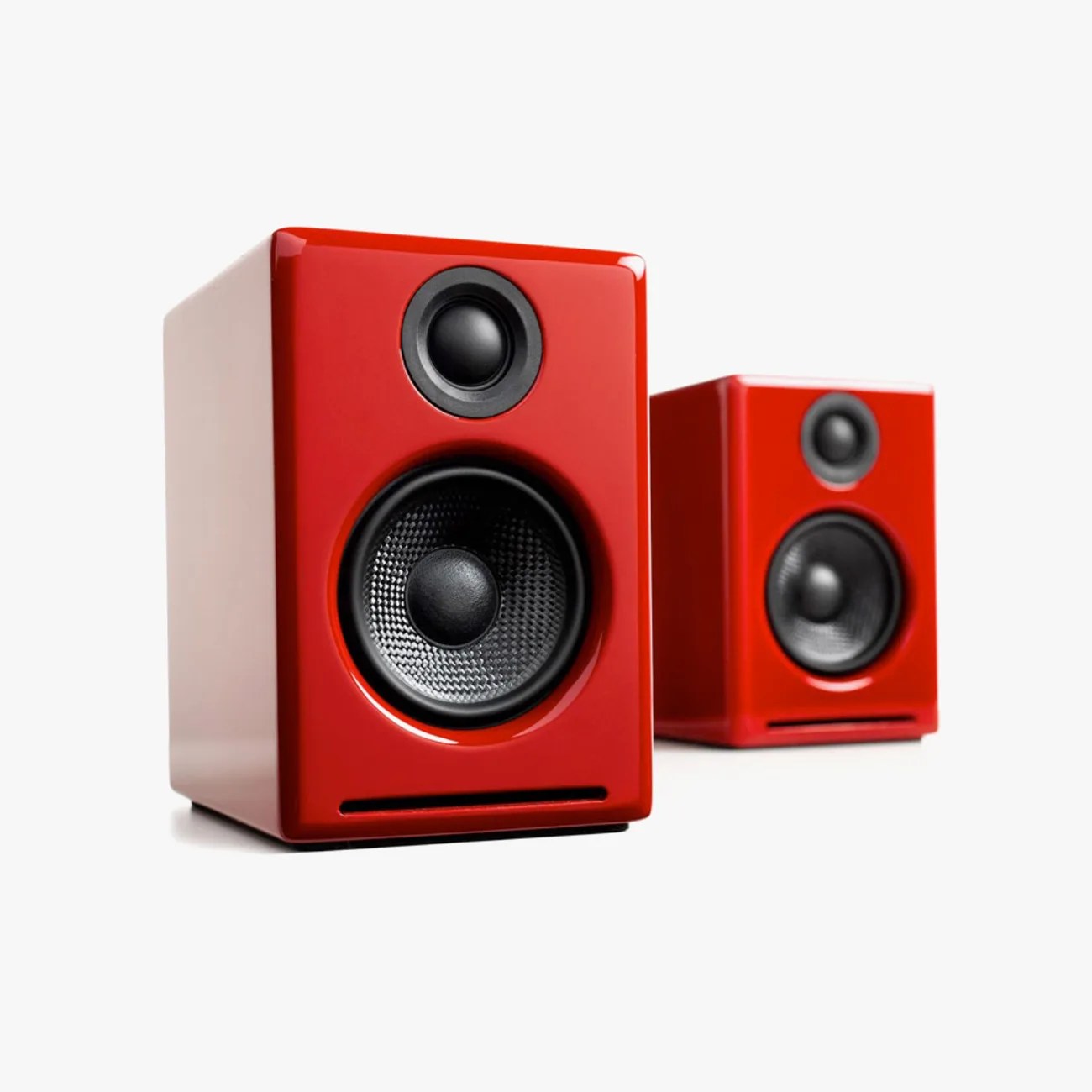 Pair of glossy red bookshelf speakers with black drivers on a white background.