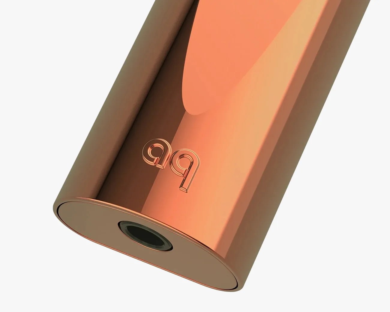 Close-up of a shiny copper-colored cylindrical object with a black circular opening and embossed "aq" logo.