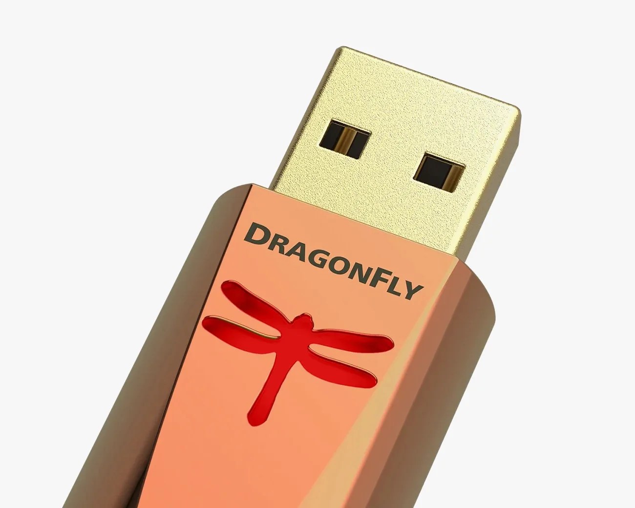 Close-up of a gold USB drive with a copper-colored body featuring a red dragonfly logo and the word "DRAGONFLY.