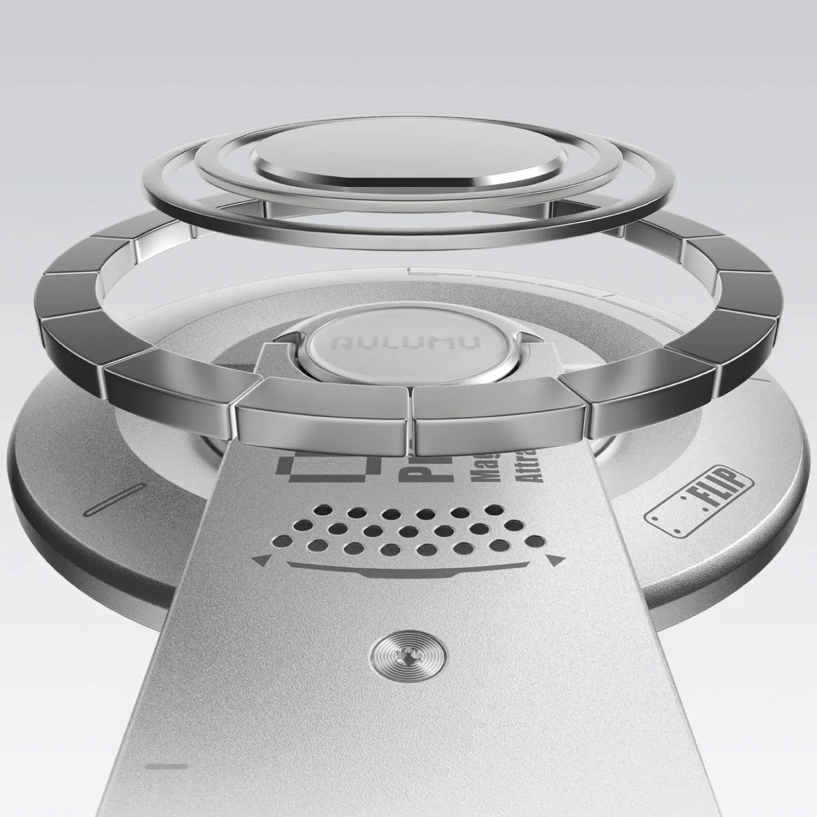 Close-up of a metallic circular component with segmented ring and concentric rings above a device labeled "FLIP.