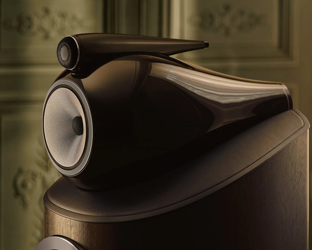 Glossy black high-end speaker with a mesh-covered woofer and a separate tweeter on top.