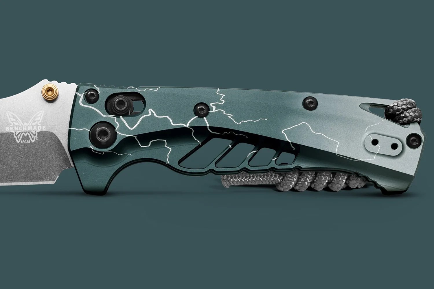 Close-up of a Benchmade folding knife handle in matte green with white lightning pattern and black screws.