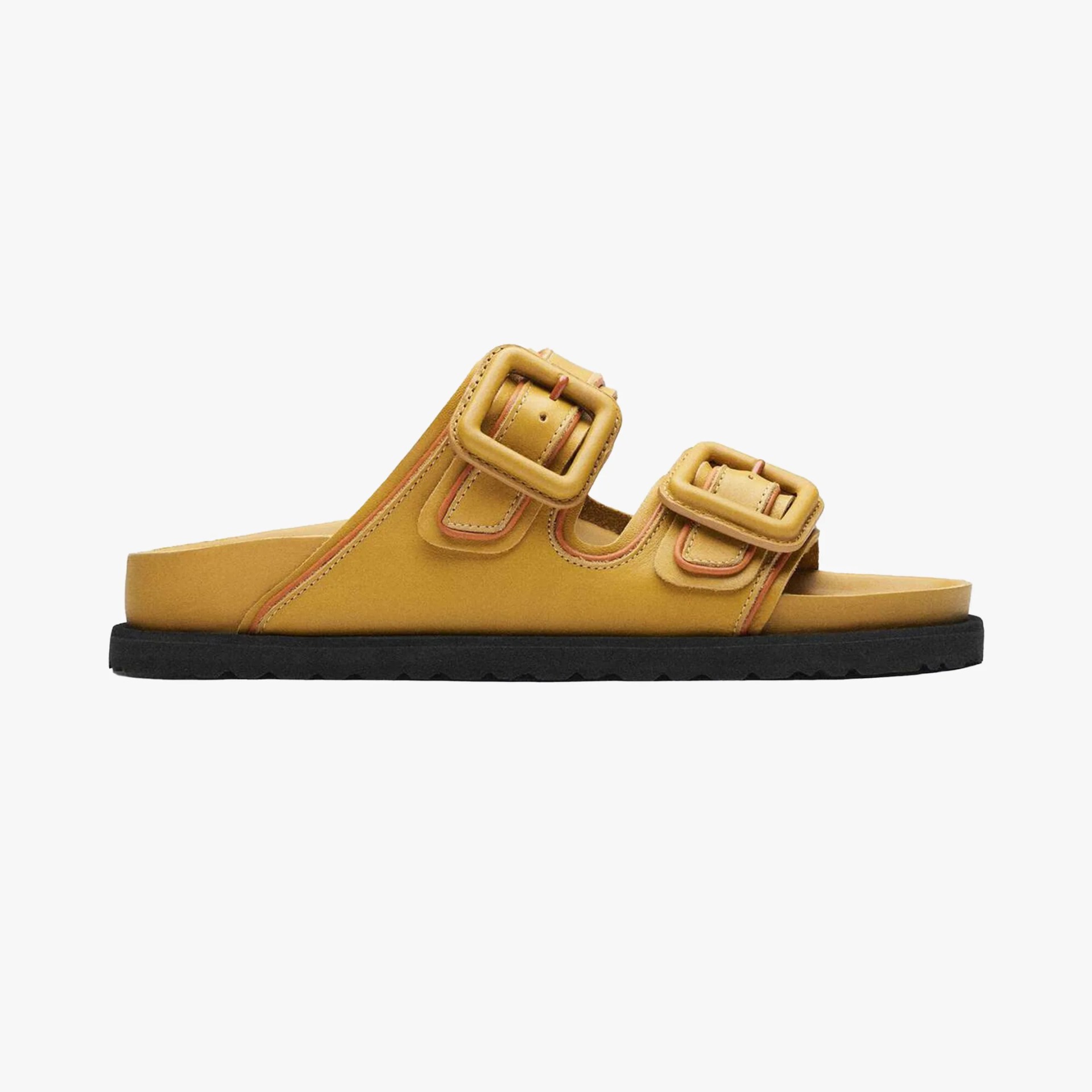 Yellow leather slide sandal with two large square buckles and a black sole.
