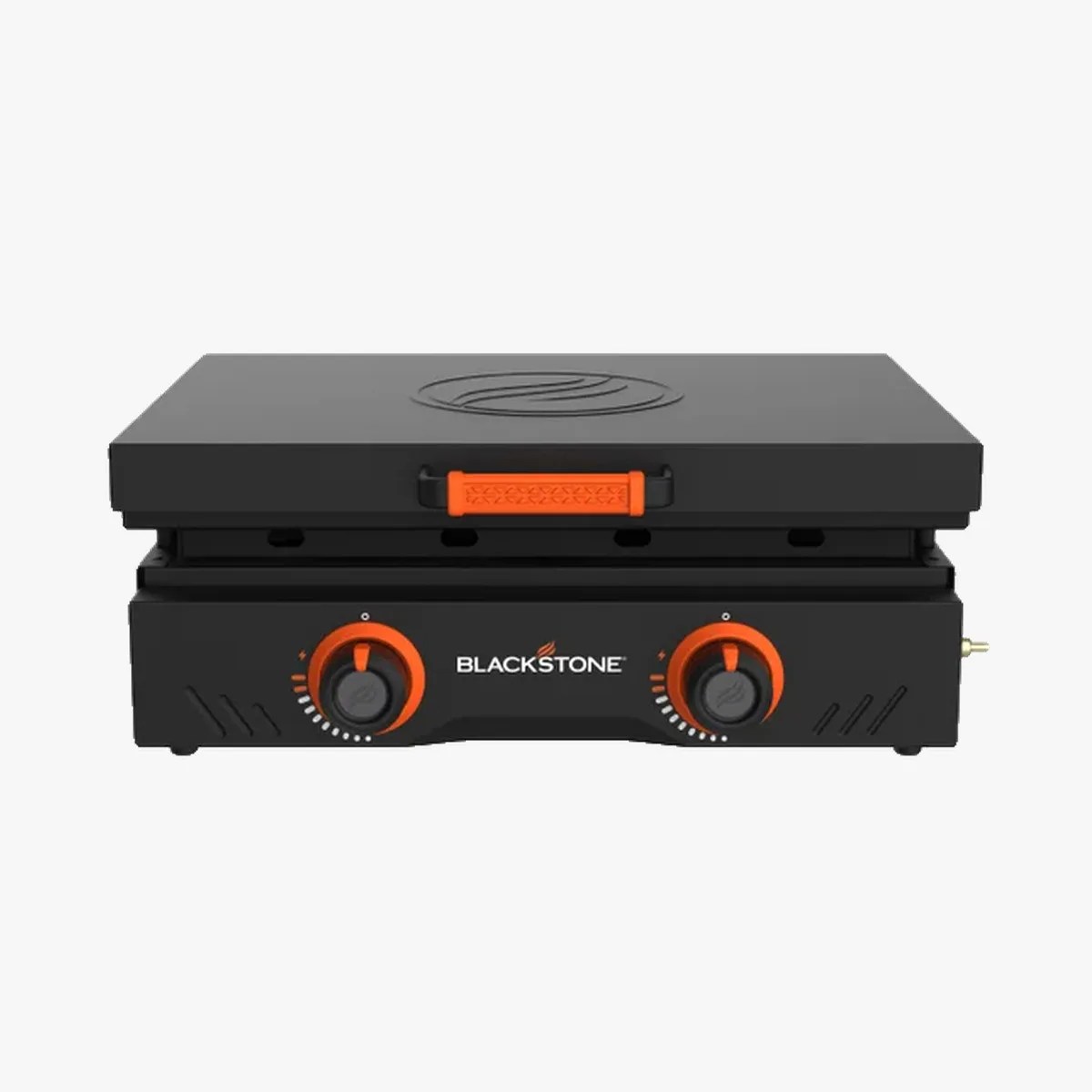 Blackstone portable gas griddle with two orange control knobs and a closed lid.