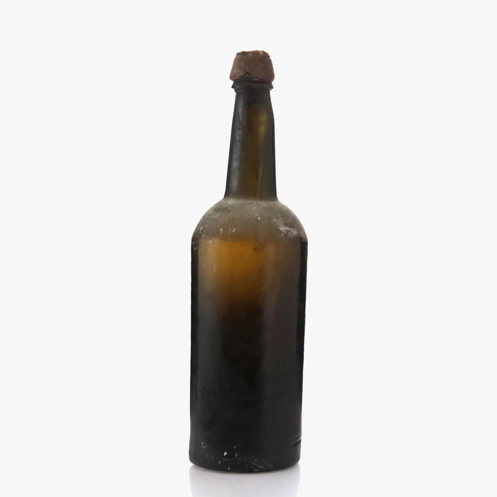Tall dark brown glass bottle with a worn cork stopper and dust on the surface.