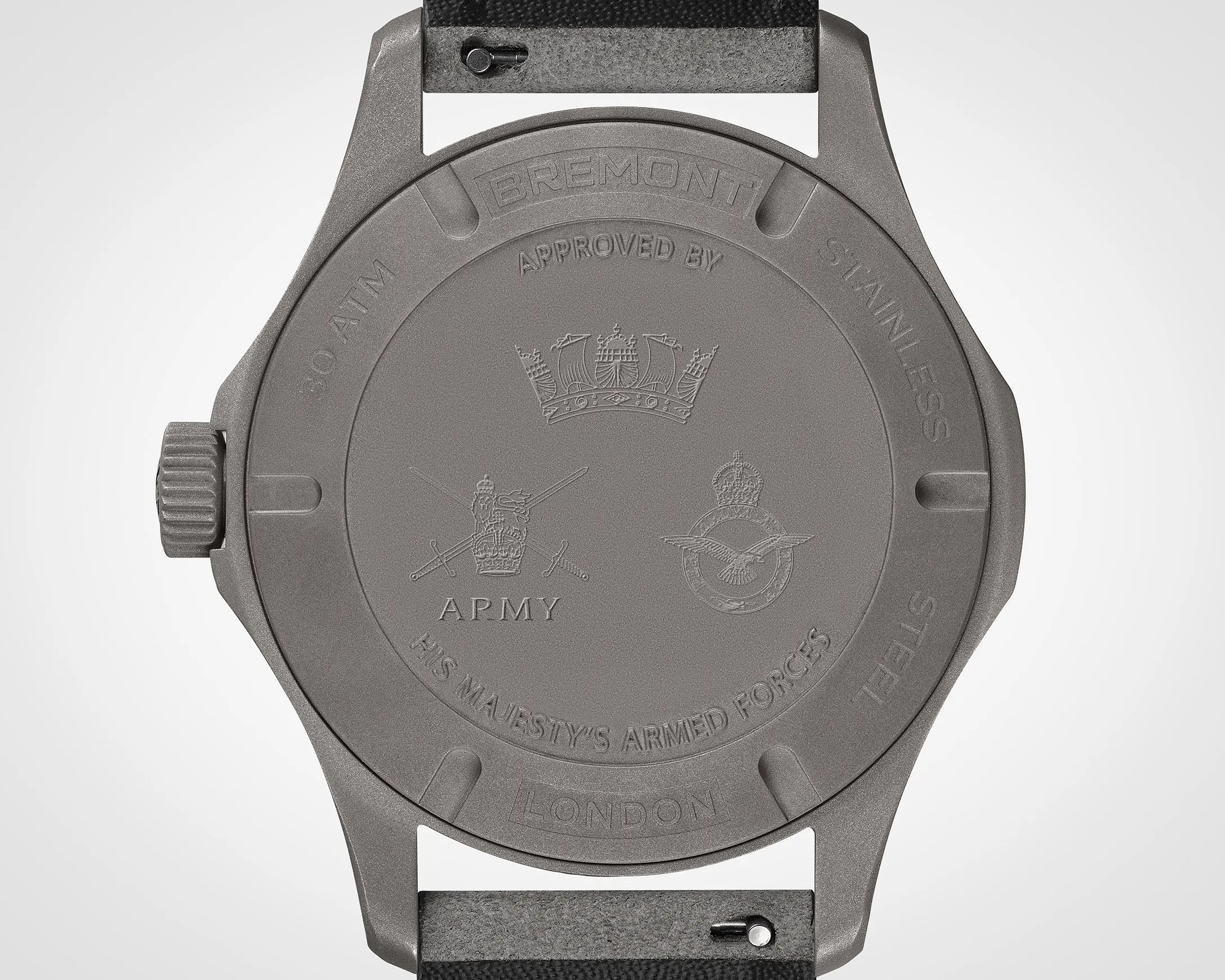 Matte gray stainless steel watch case back with engravings including "Bremont," "30 ATM," "Army," and "His Majesty's Armed Forces.