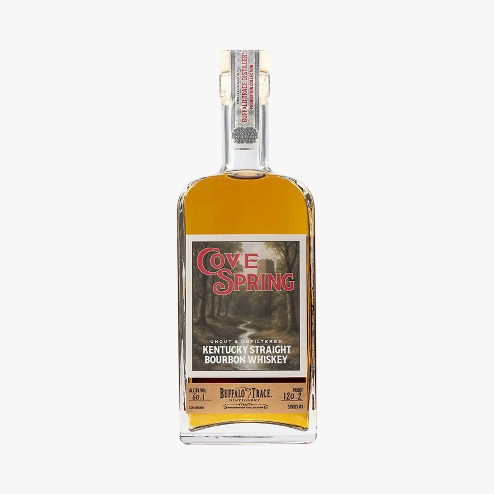 Rectangular bottle of Cove Spring Kentucky Straight Bourbon Whiskey with amber liquid and a label featuring a forest scene.
