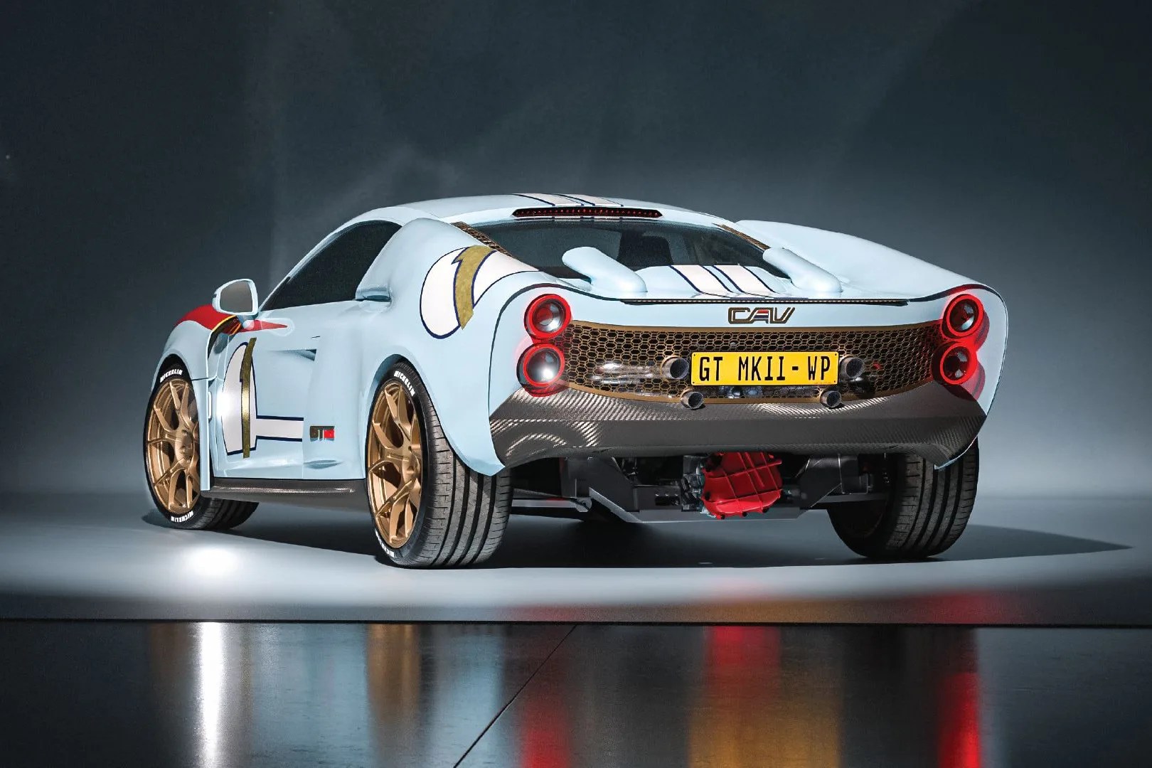 Light blue sports car with gold rims, red and white racing decals, and a rear license plate reading "GT MKII - WP.