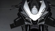 Front view of a black and silver sport motorcycle with angular design and aerodynamic winglets.
