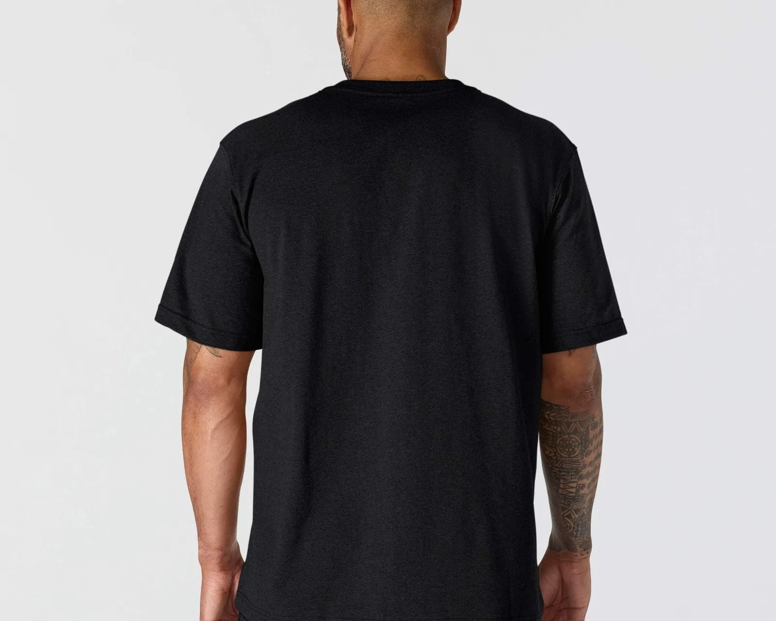 Black short-sleeve t-shirt worn by a person showing the back, with a tattooed right forearm visible.