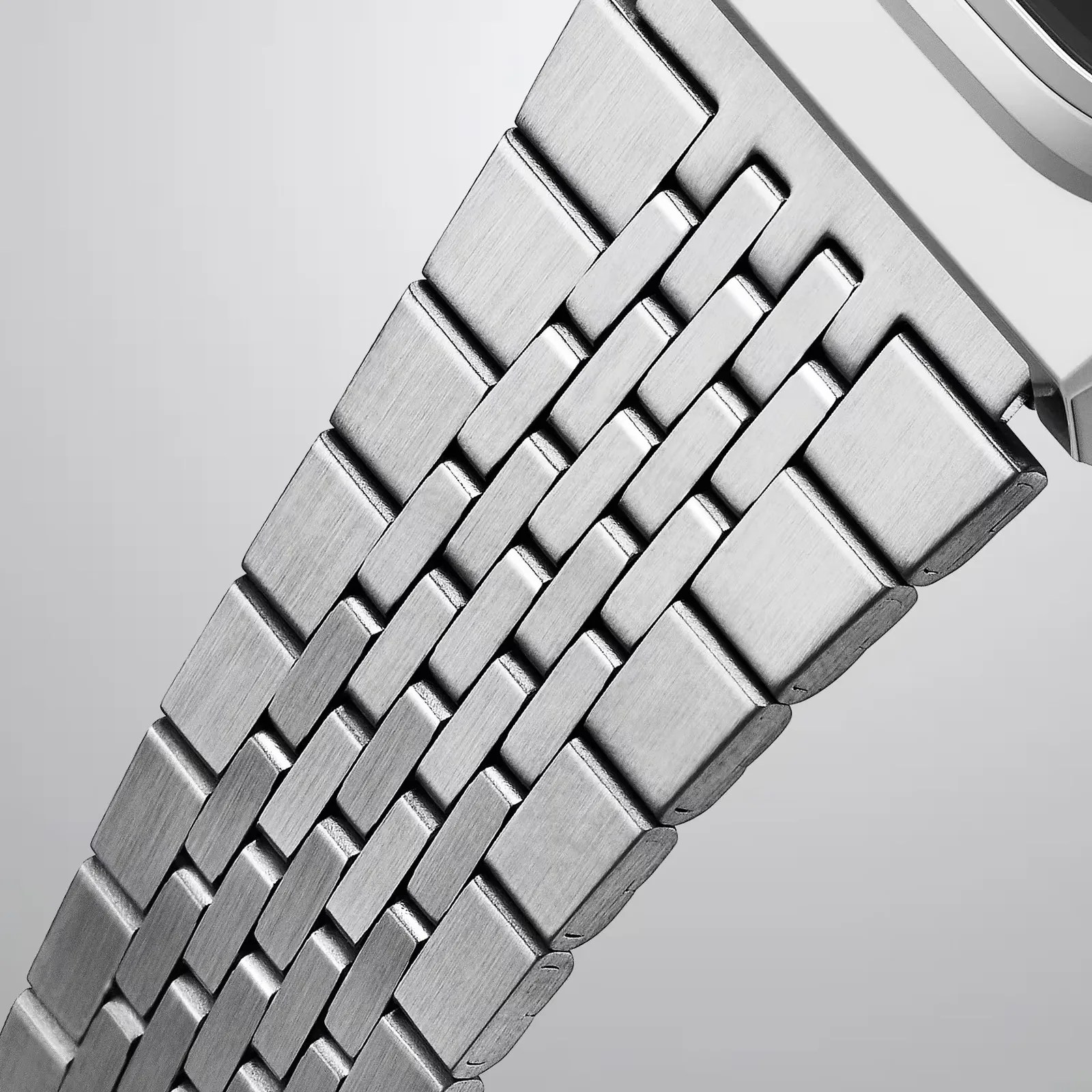 Close-up of a silver metal watch band with brushed finish links.
