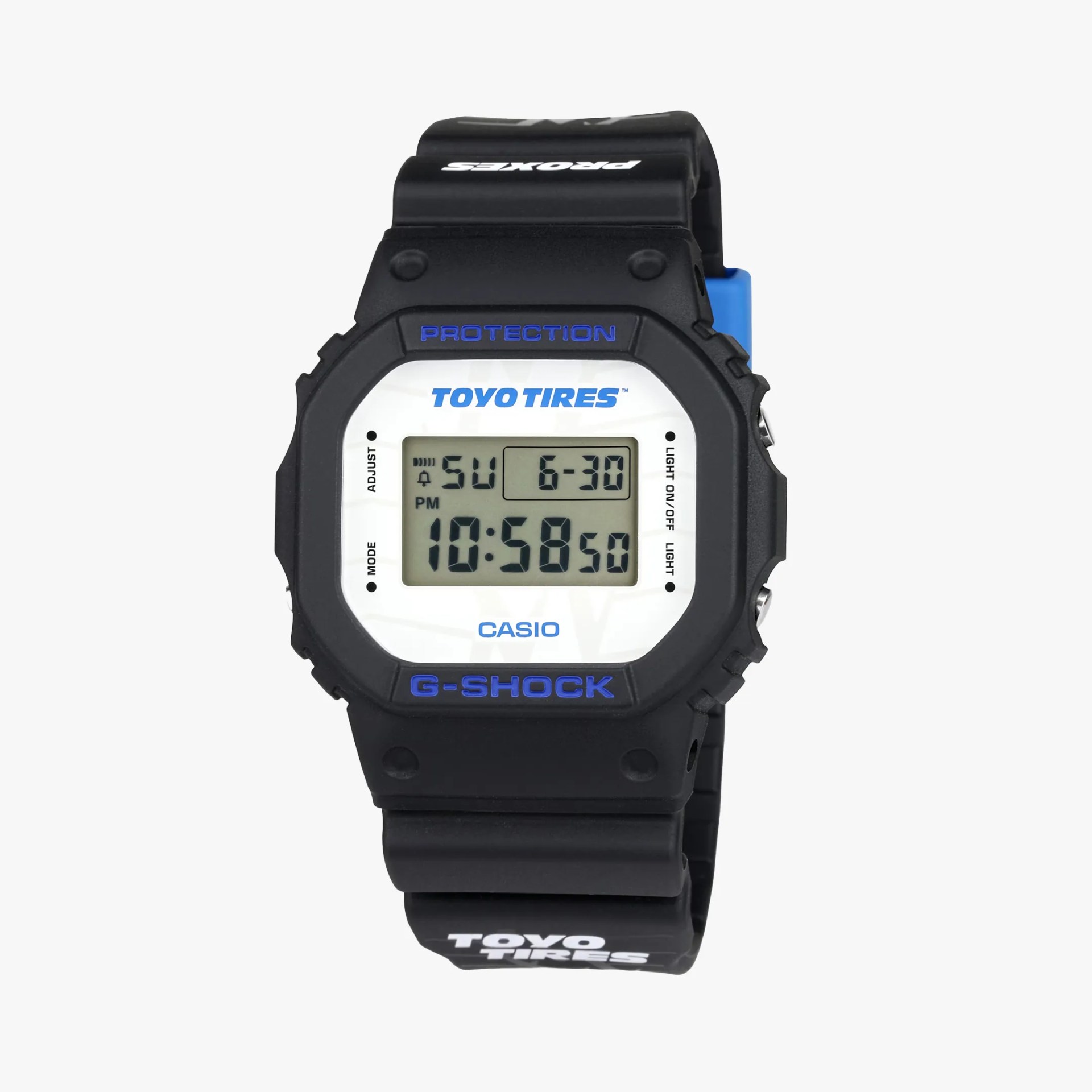 Black Casio G-Shock digital watch with white face and blue "Toyo Tires" and "G-Shock" branding on bezel and strap.